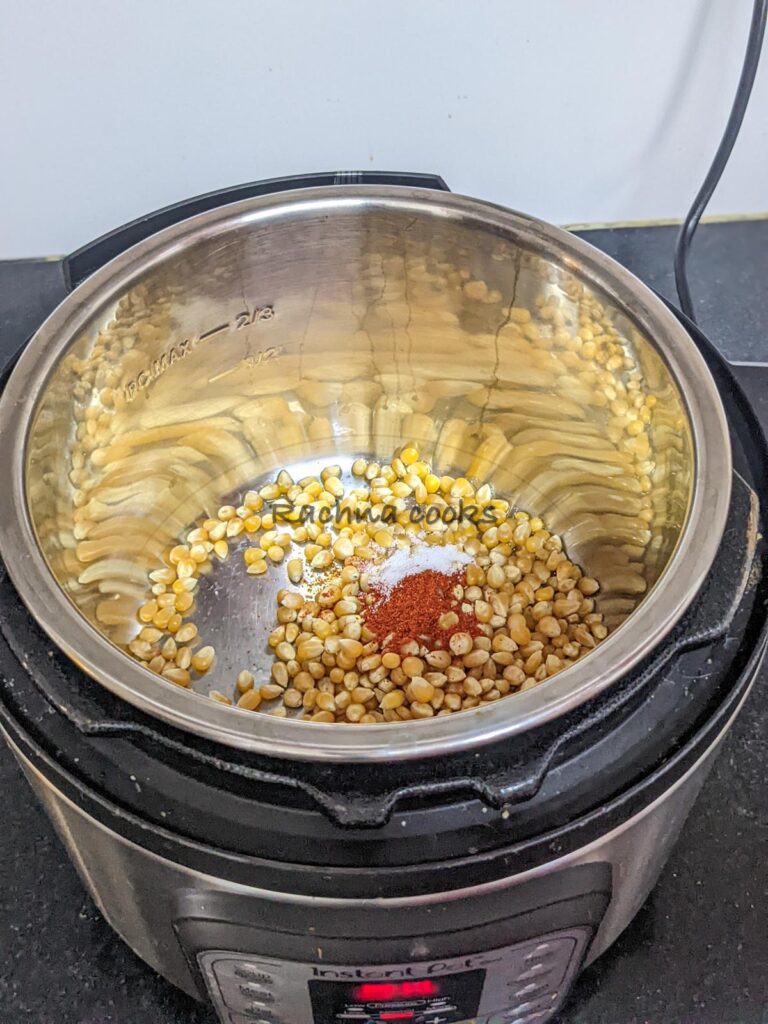 Unpopped corn with oil, salt, paprika, pepper and turmeric powder in Instant pot.