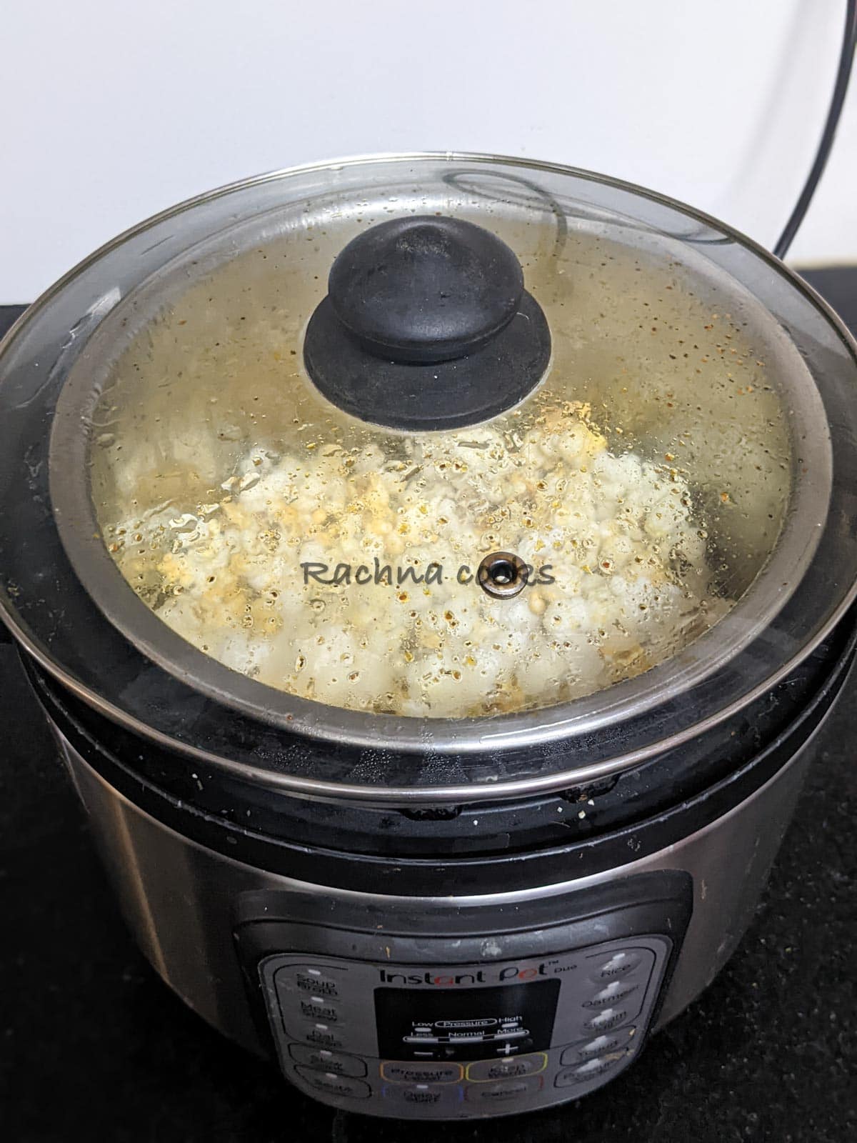Popping corn in Instant pot with a glass lid on top.