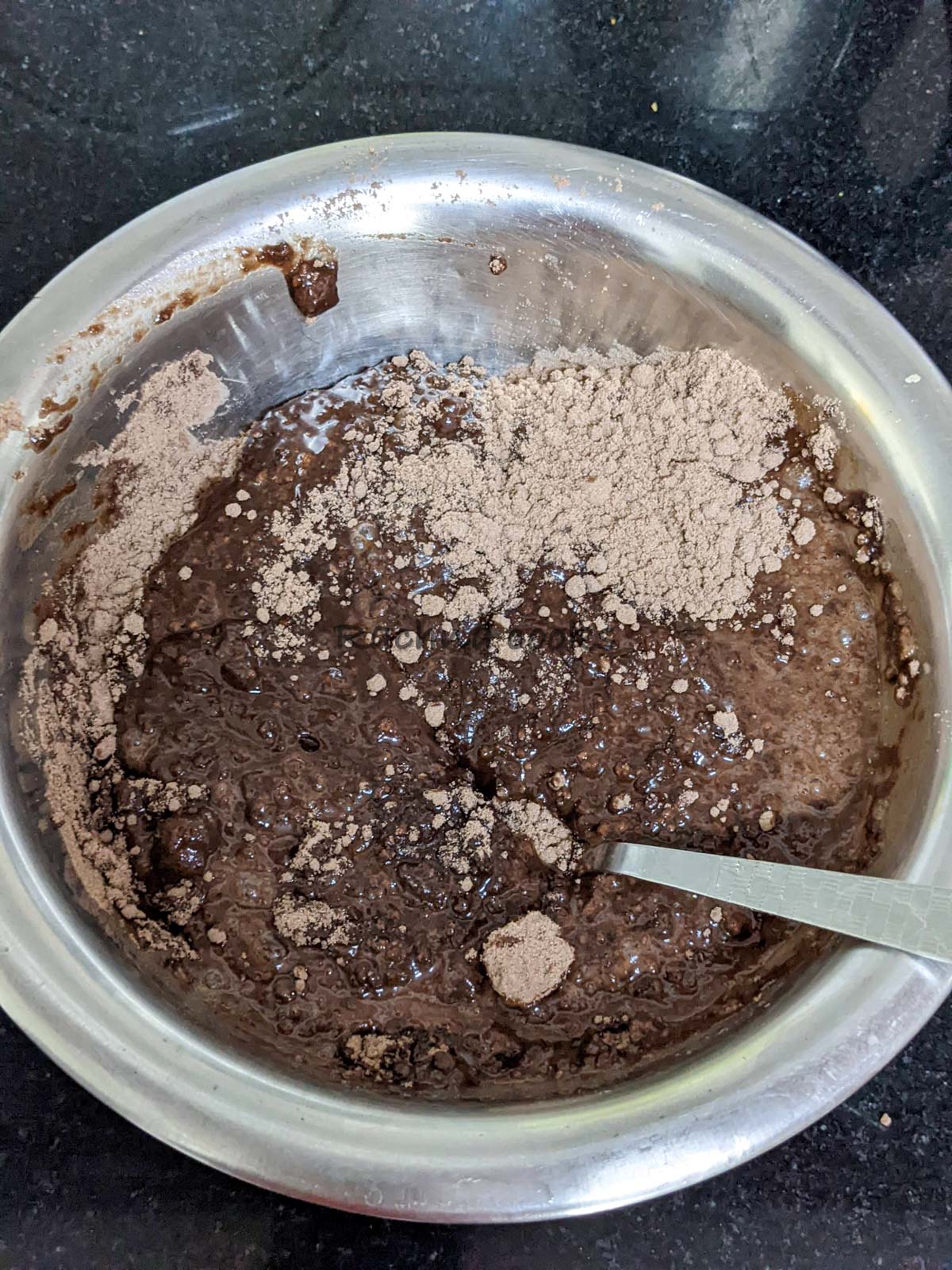 Mixing cake batter in a steel bowl