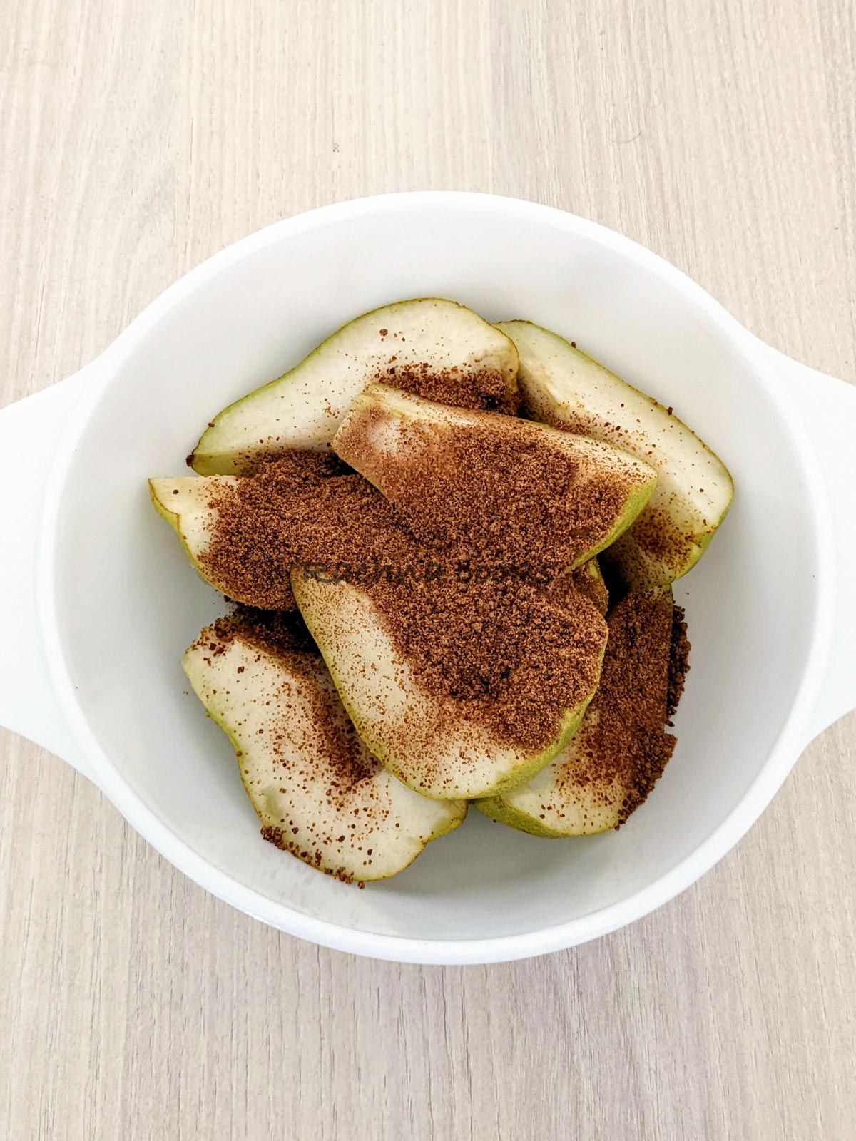Brown sugar and cinnamon sprinkled all over pear segments.