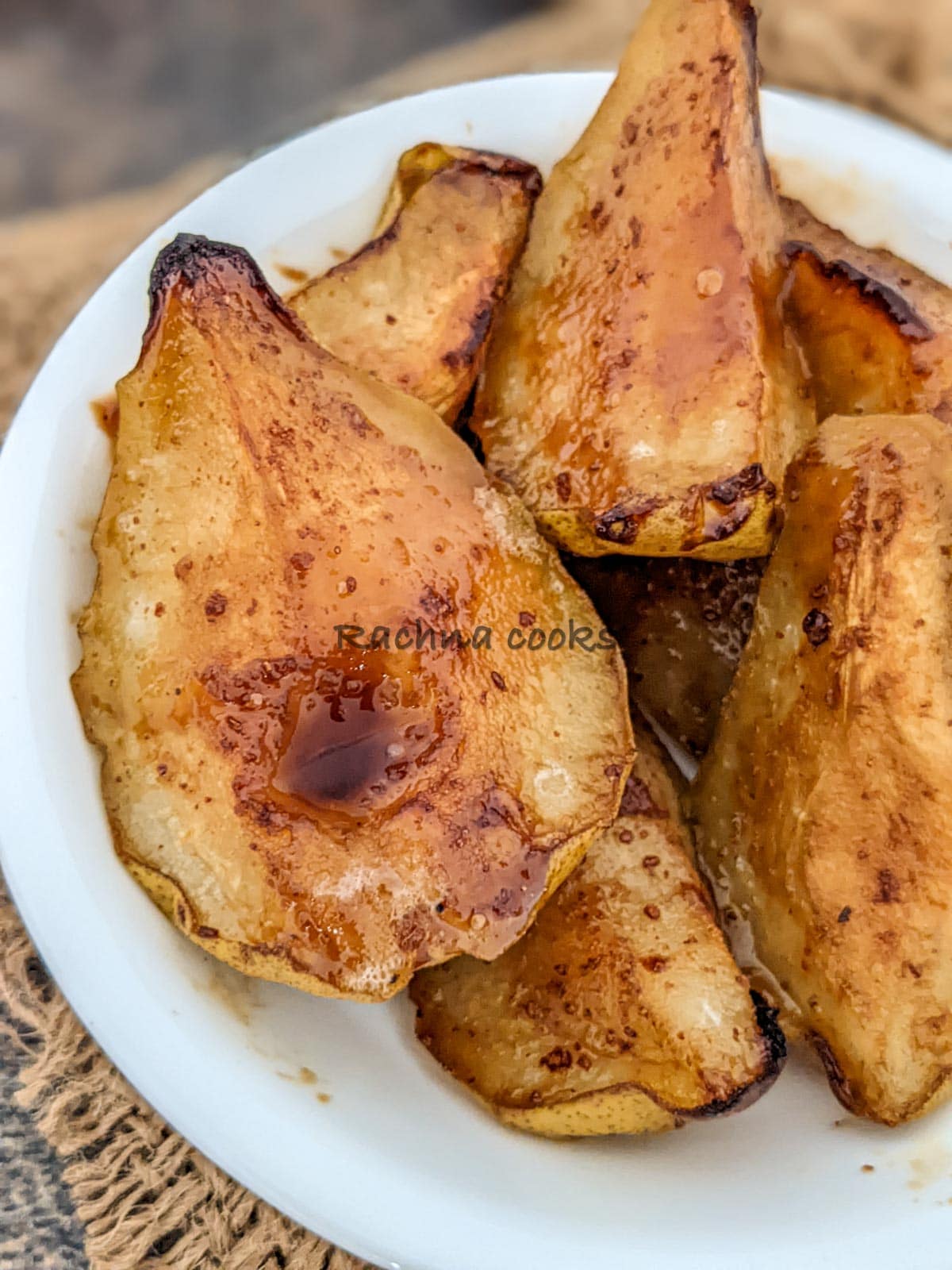 Caramelised air fryer pears on a white plate.