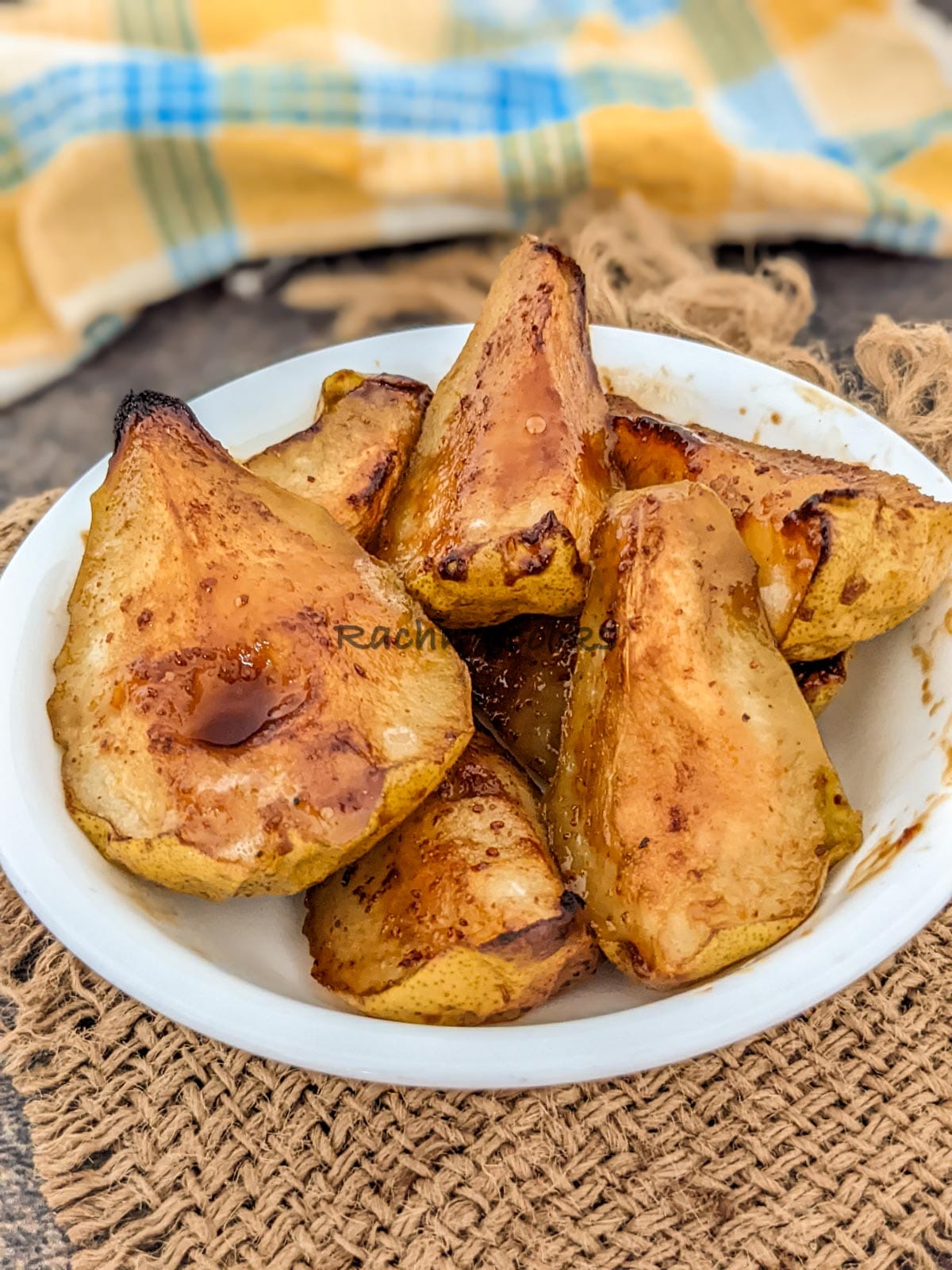 Caramelised air fryer pears on a white plate.