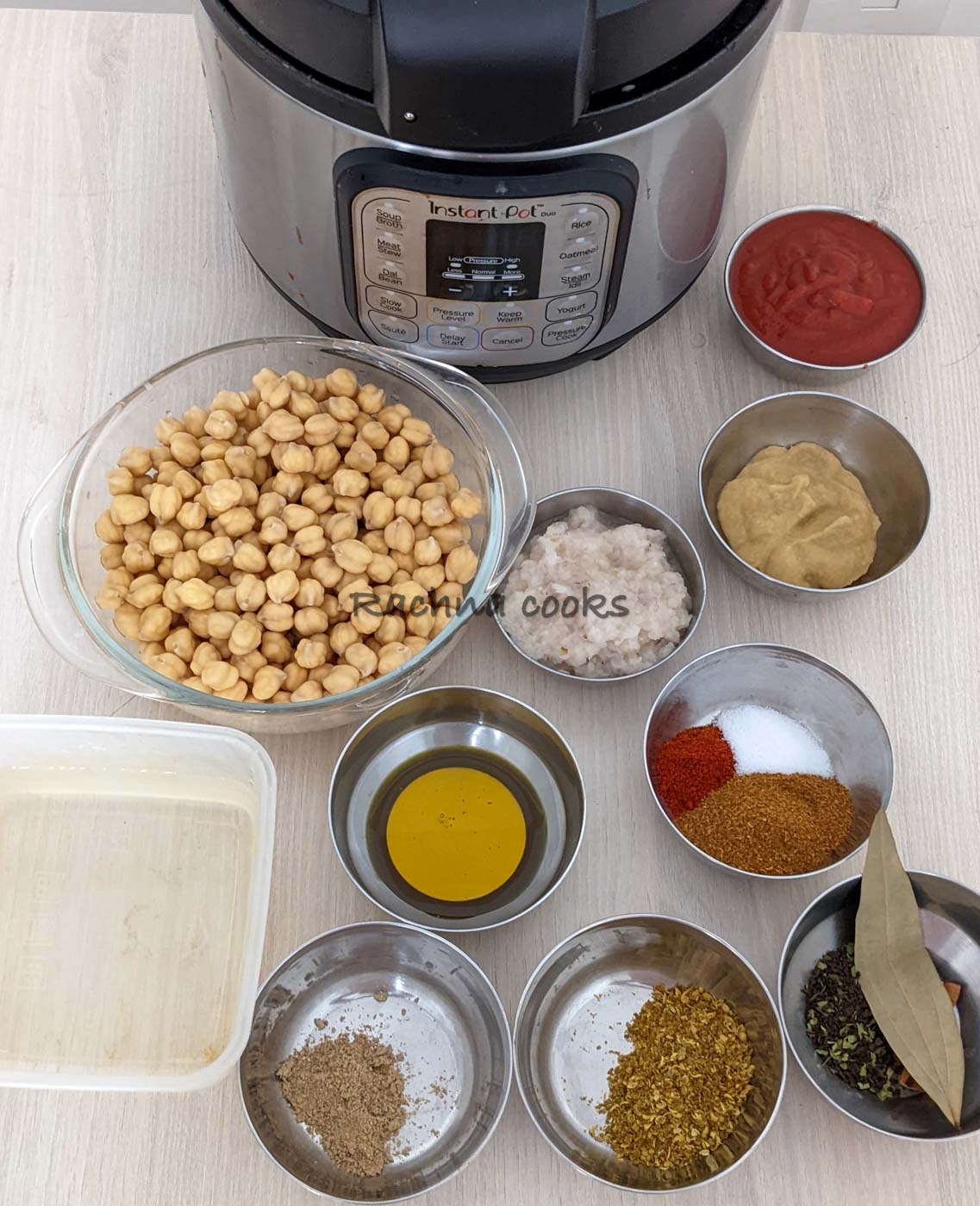 Ingredients to make instant pot chana masala laid out in bowls.