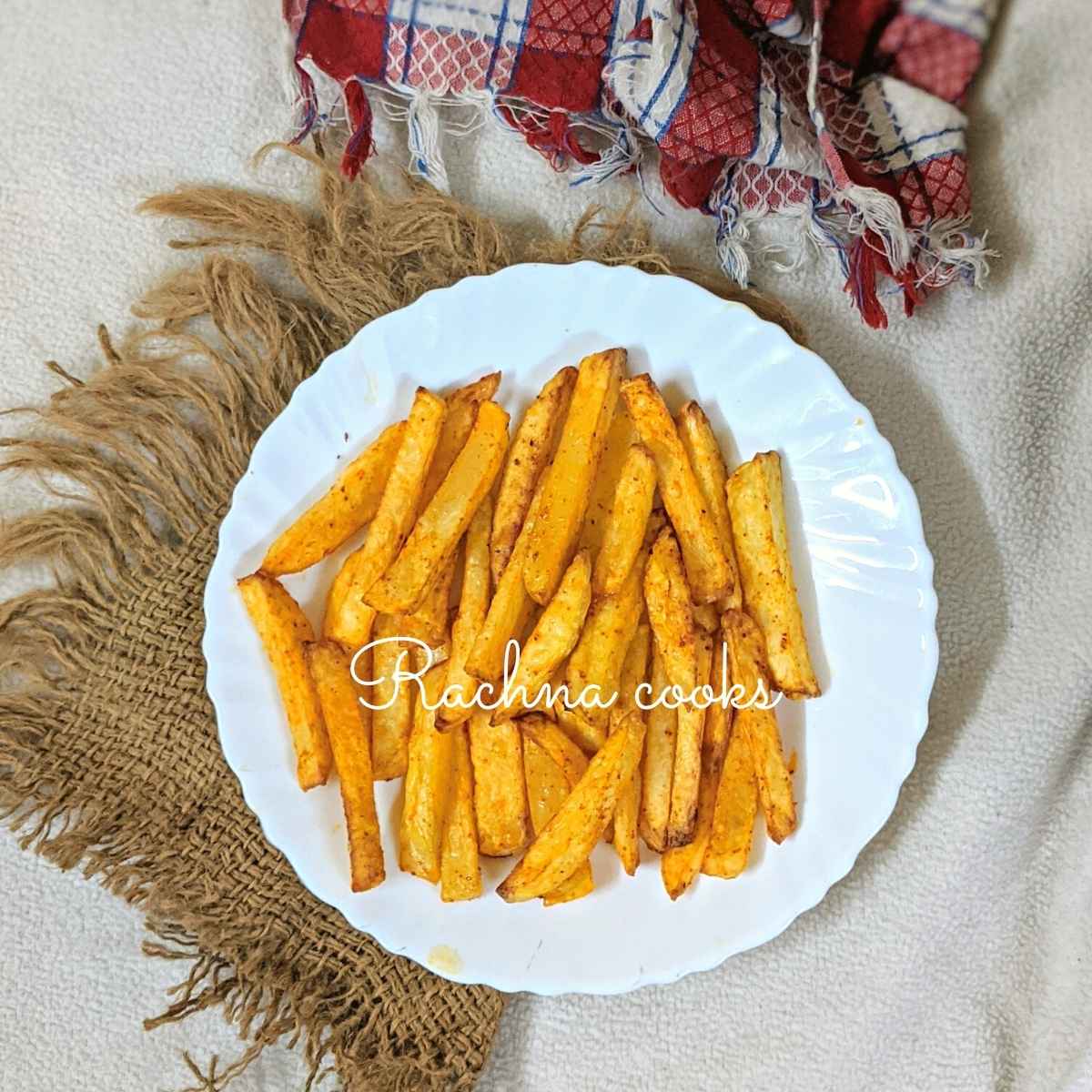 air fried french fries served on a white plate.