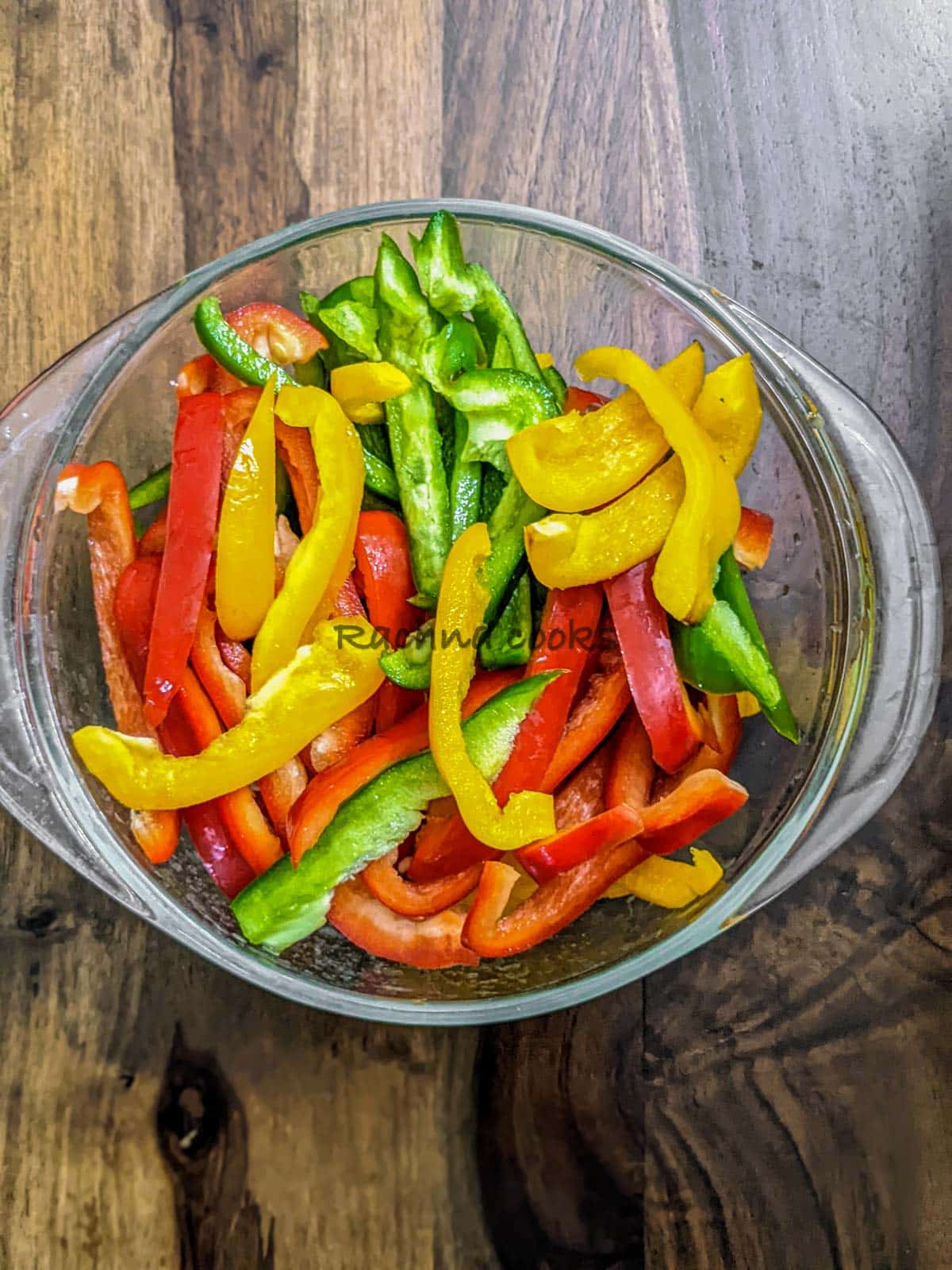 Equal long slices of peppers in a bowl.