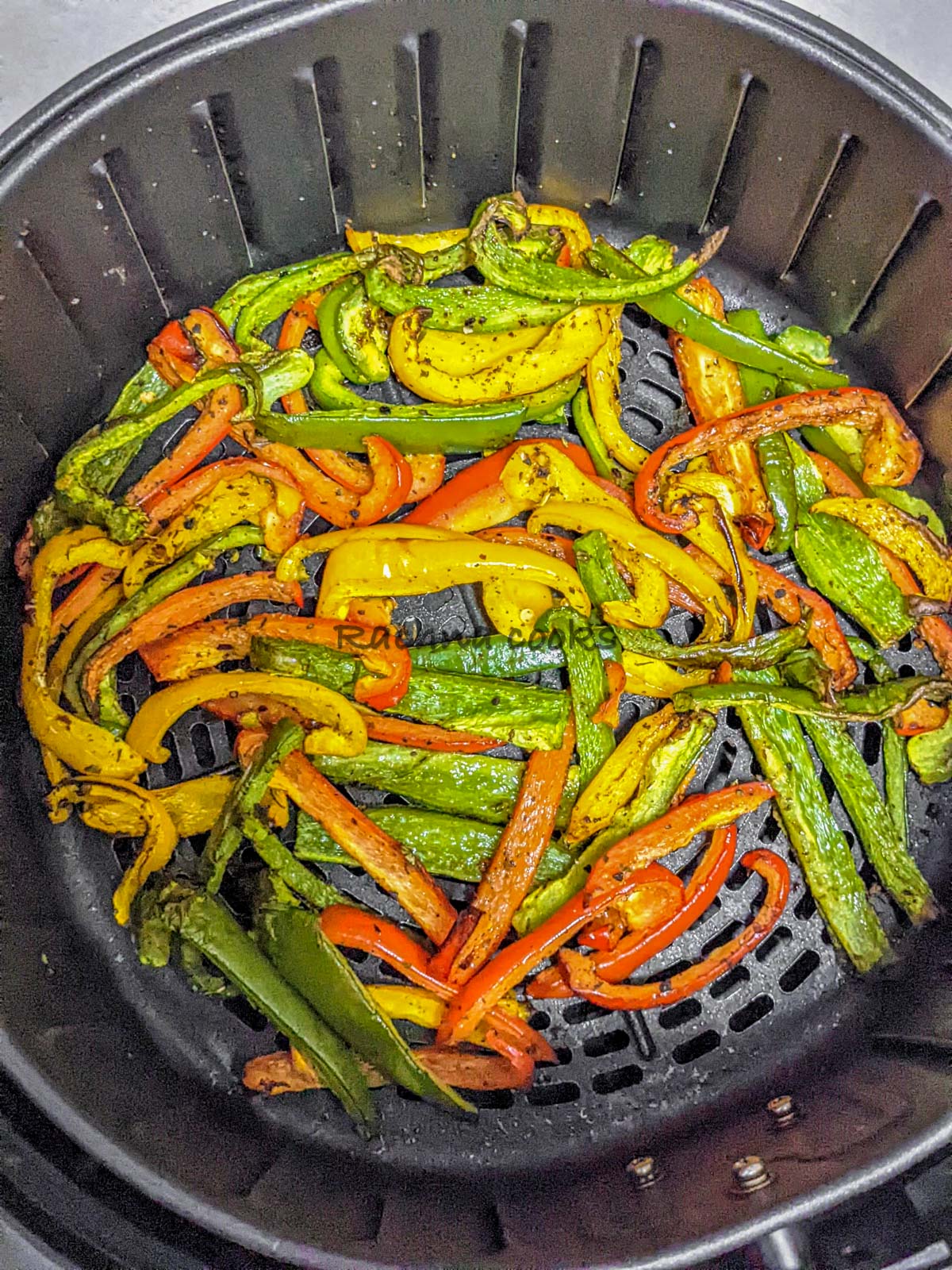 Peppers after air frying in air fryer basket.