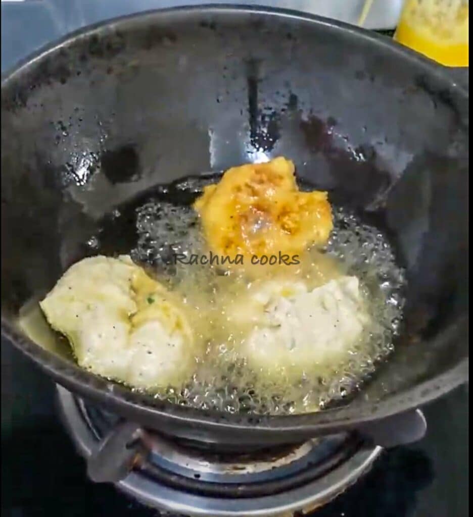 Medu vadas being deep fried in a wok