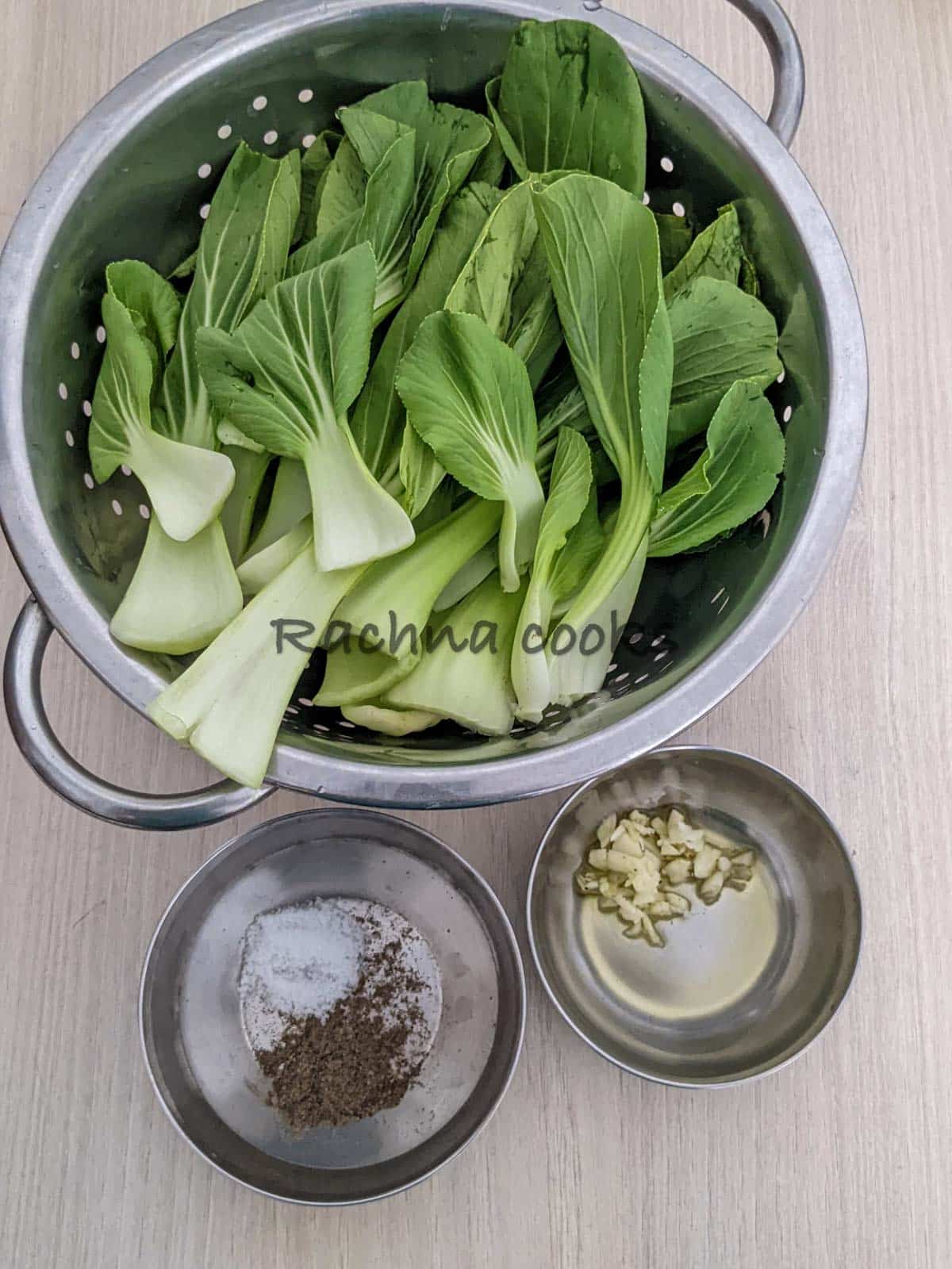 Washed and dried bok choy, salt, pepper in a shallow bowl. Virgin olive oil and minced garlic in another bowl.