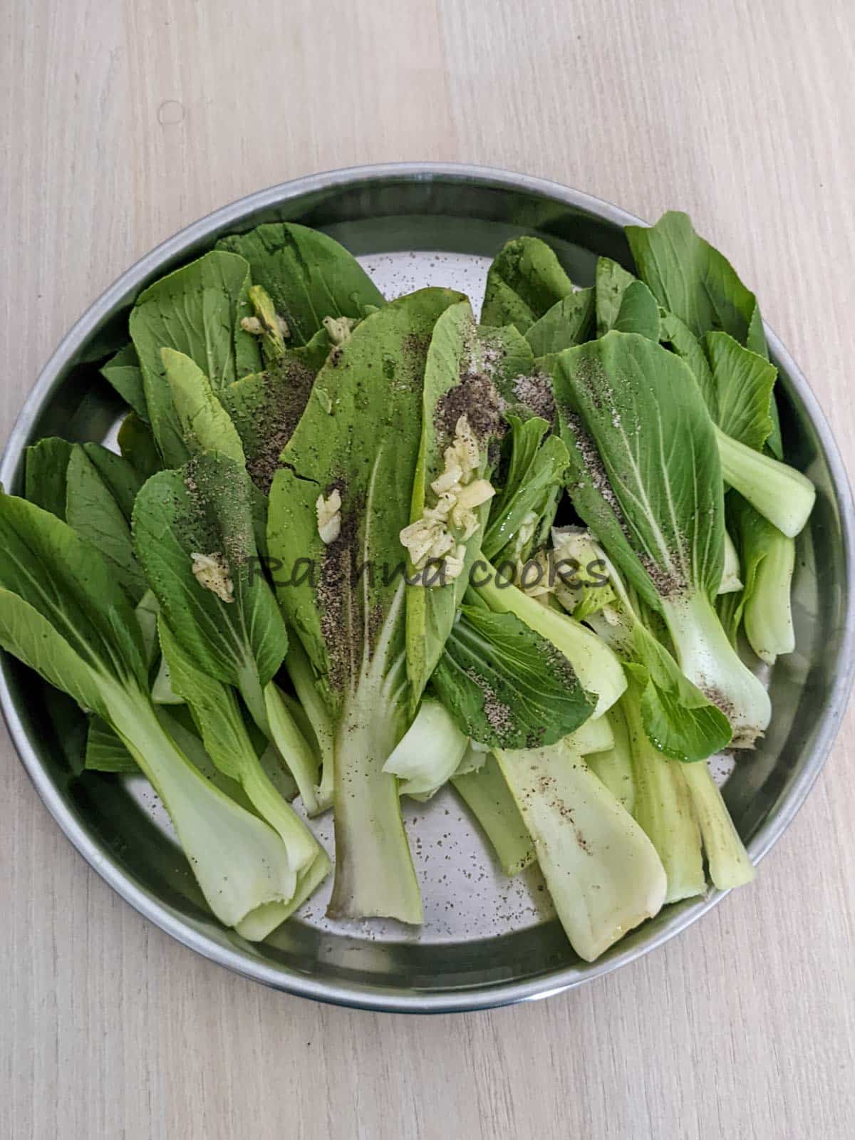 Bok choy tossed with oil and seasonings.