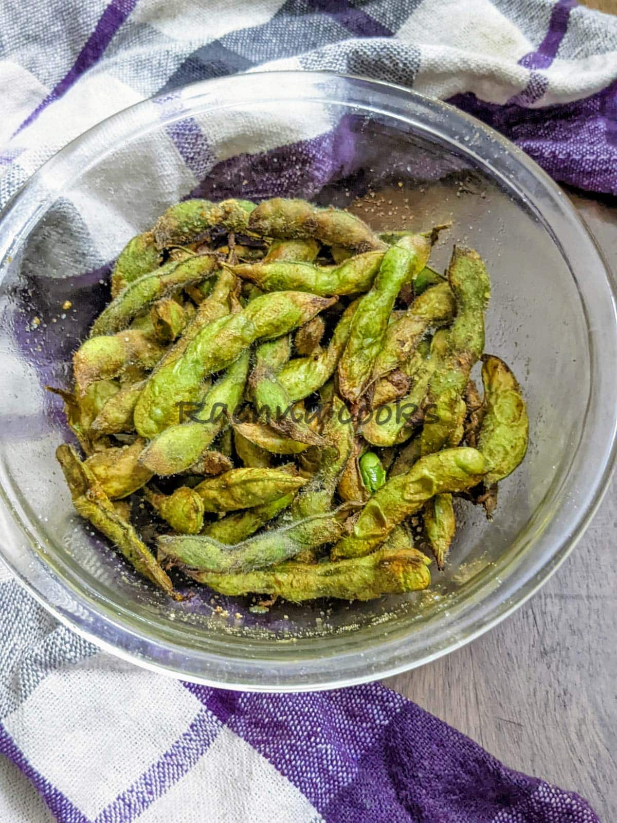 air fried edamame pods in a glass bowl.