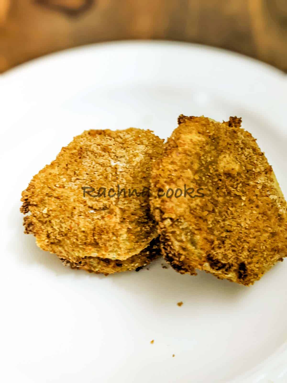 Air fried green tomato slices on a plate.