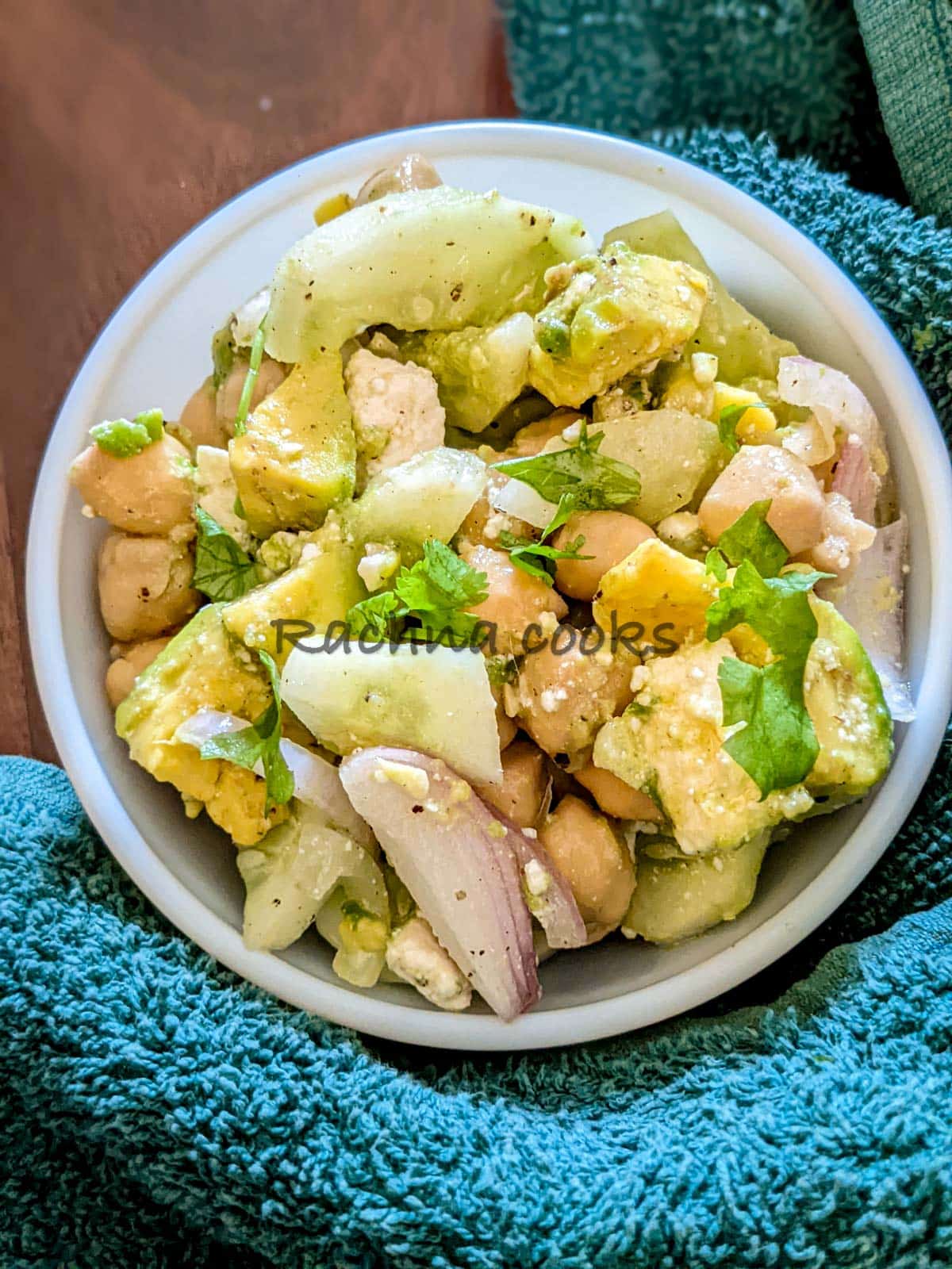 A bowl of chickpea avocado cucumber salad with feta