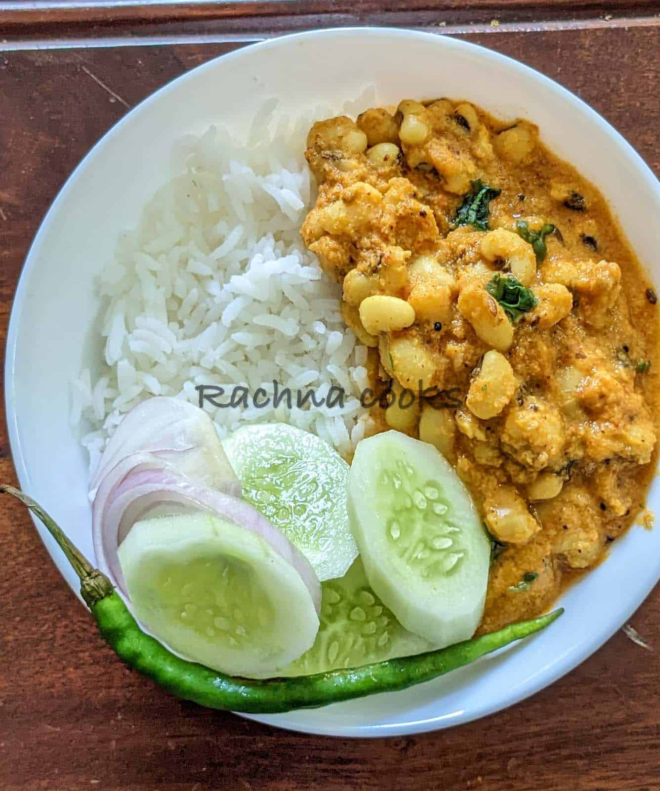Black eyed peas curry served with boiled rice and salad in a bowl.