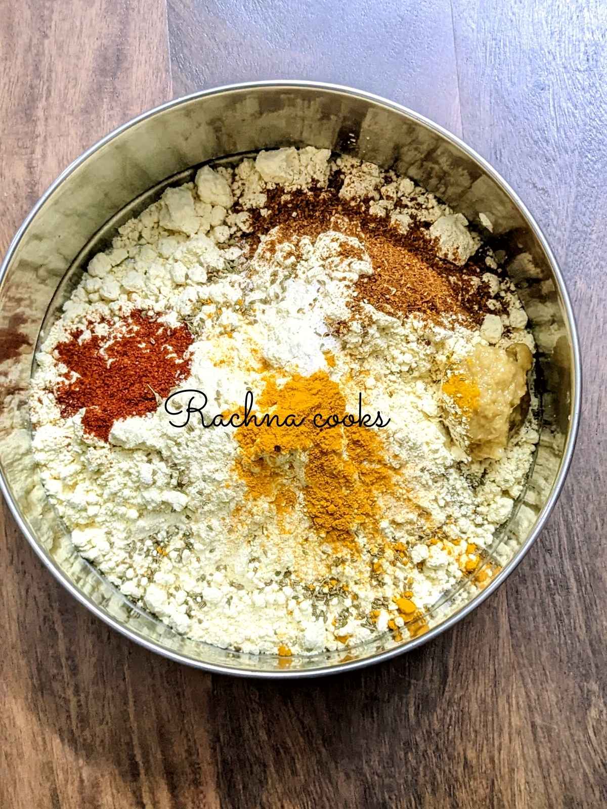 A bowl having chickpea flour, spices and salt.