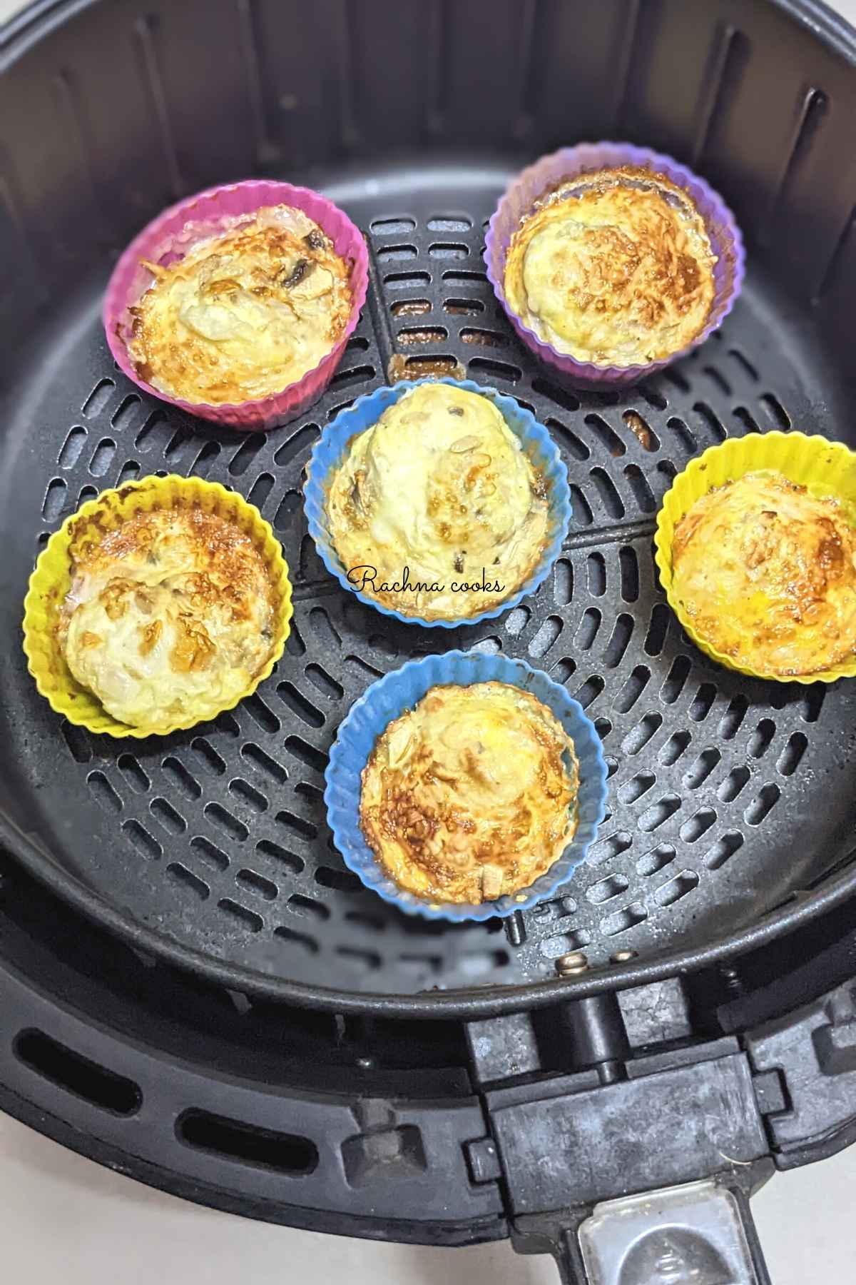 6 egg bites after air frying in air fryer basket.