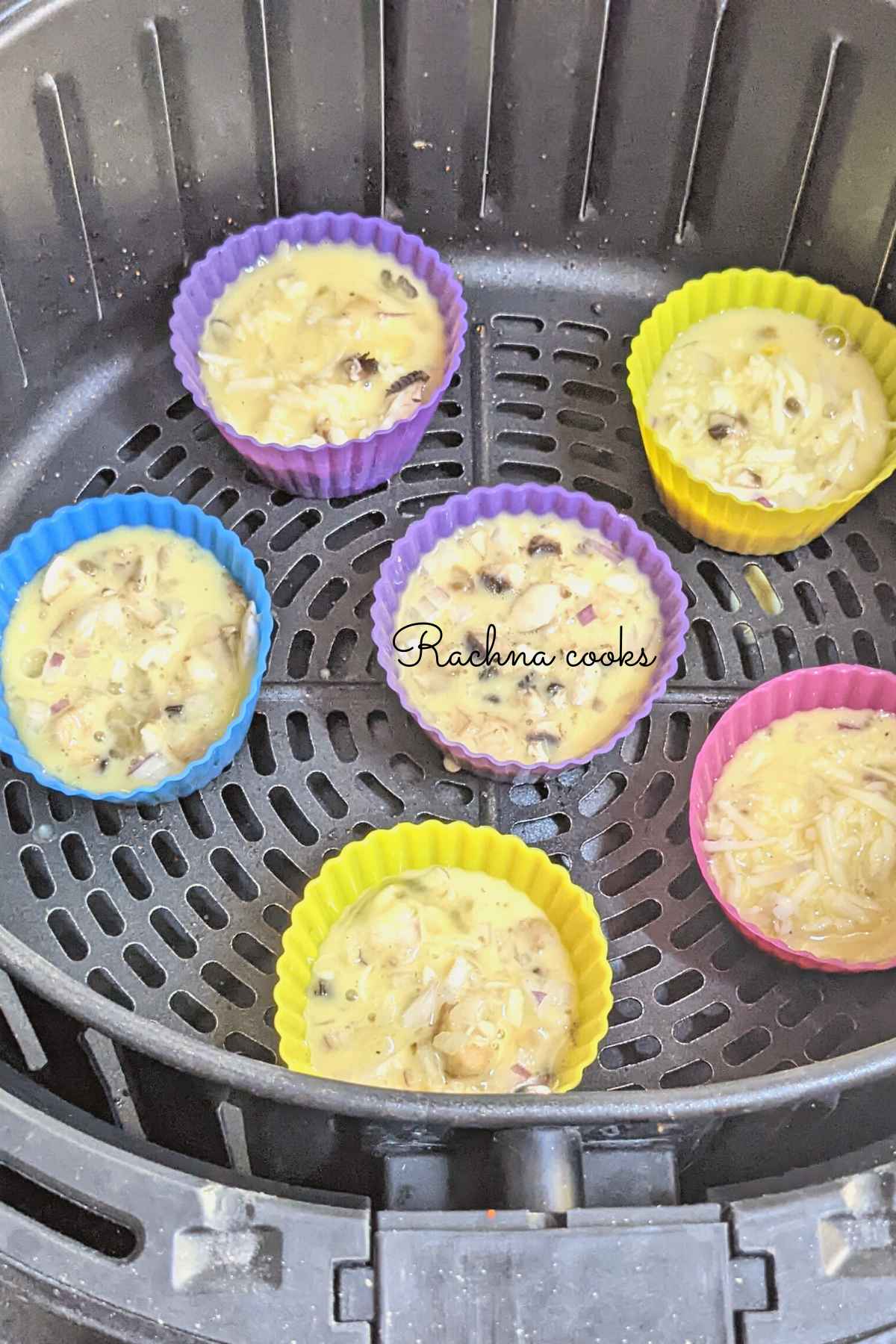 6 egg bite mix in silicone moulds in air fryer basket.