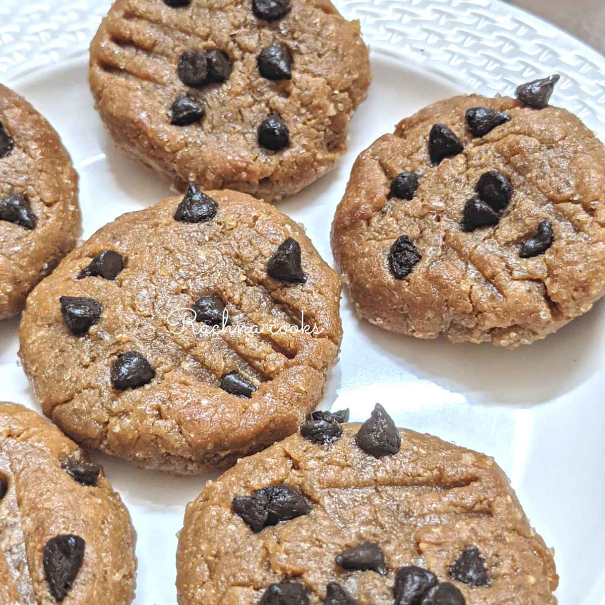 Close up of a plate of peanut butter cookies with chocolate chips.