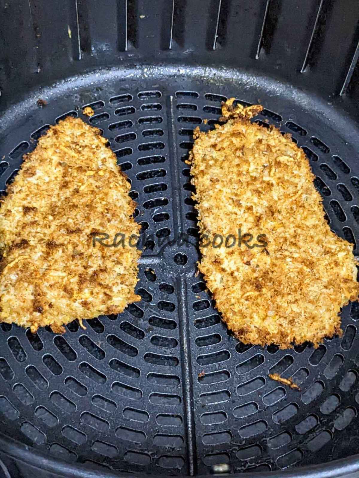 Air fried breaded chicken fillet in air fryer basket