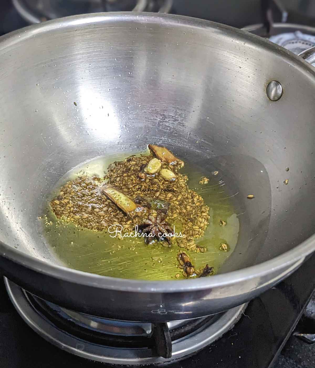 Whole spices, cumin seeds and asafetida in mustard oil in a pan.