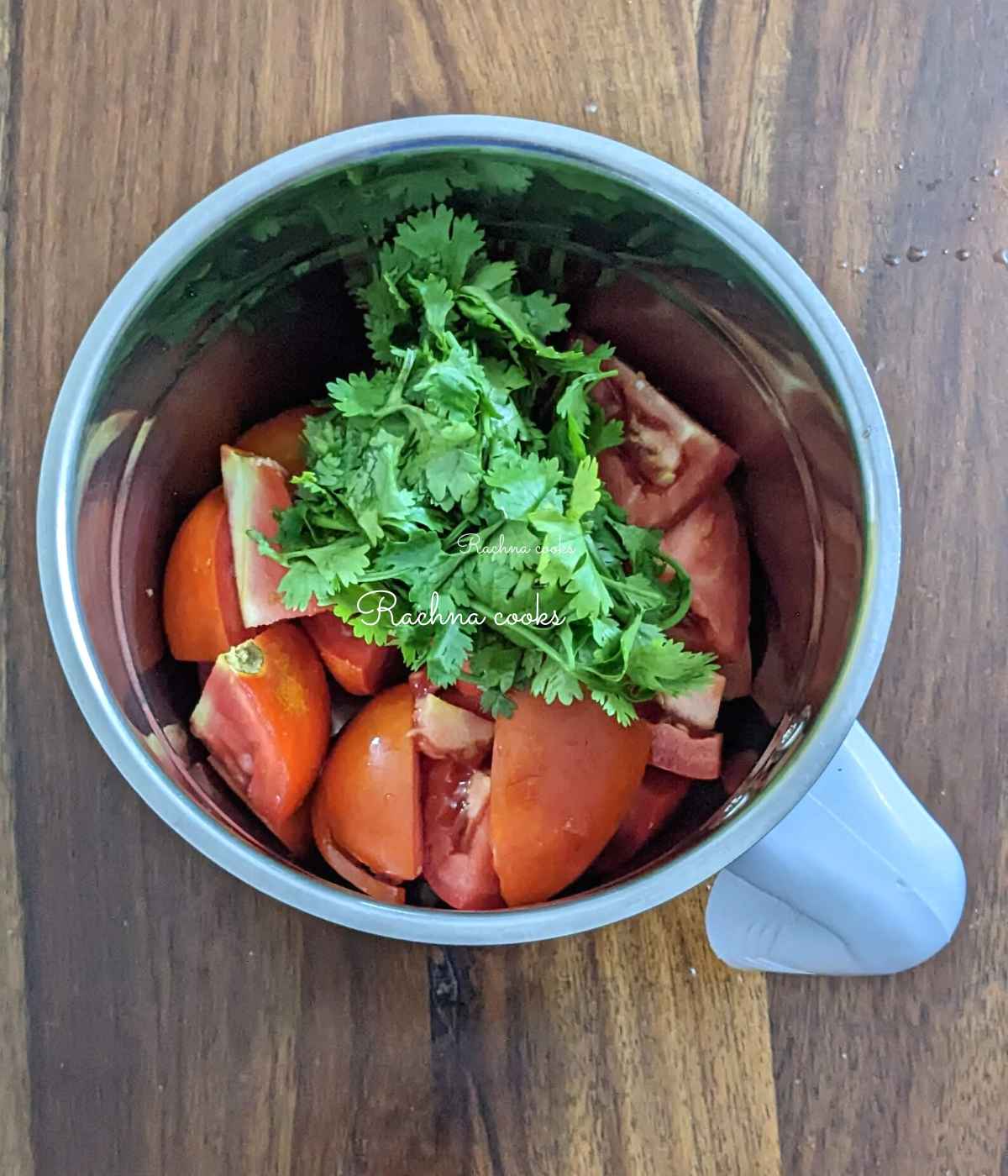 Chopped tomato, green chillies, ginger, garlic and cilantro in a blender jar