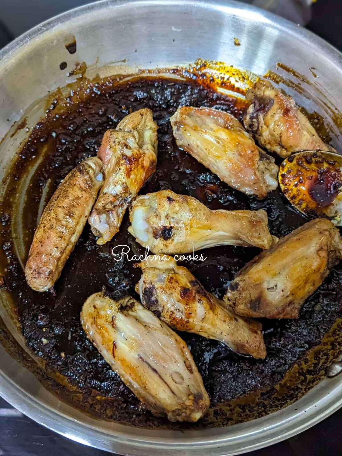 Air fried chicken wings being tossed in honey garlic sauce.