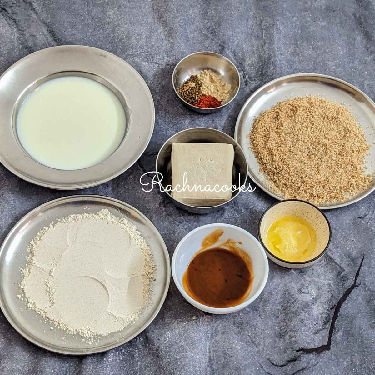 Ingredients for making buffalo tofu bites: milk, flour, breadcrumbs, medium tofu, hot sauce, butter, seasonings