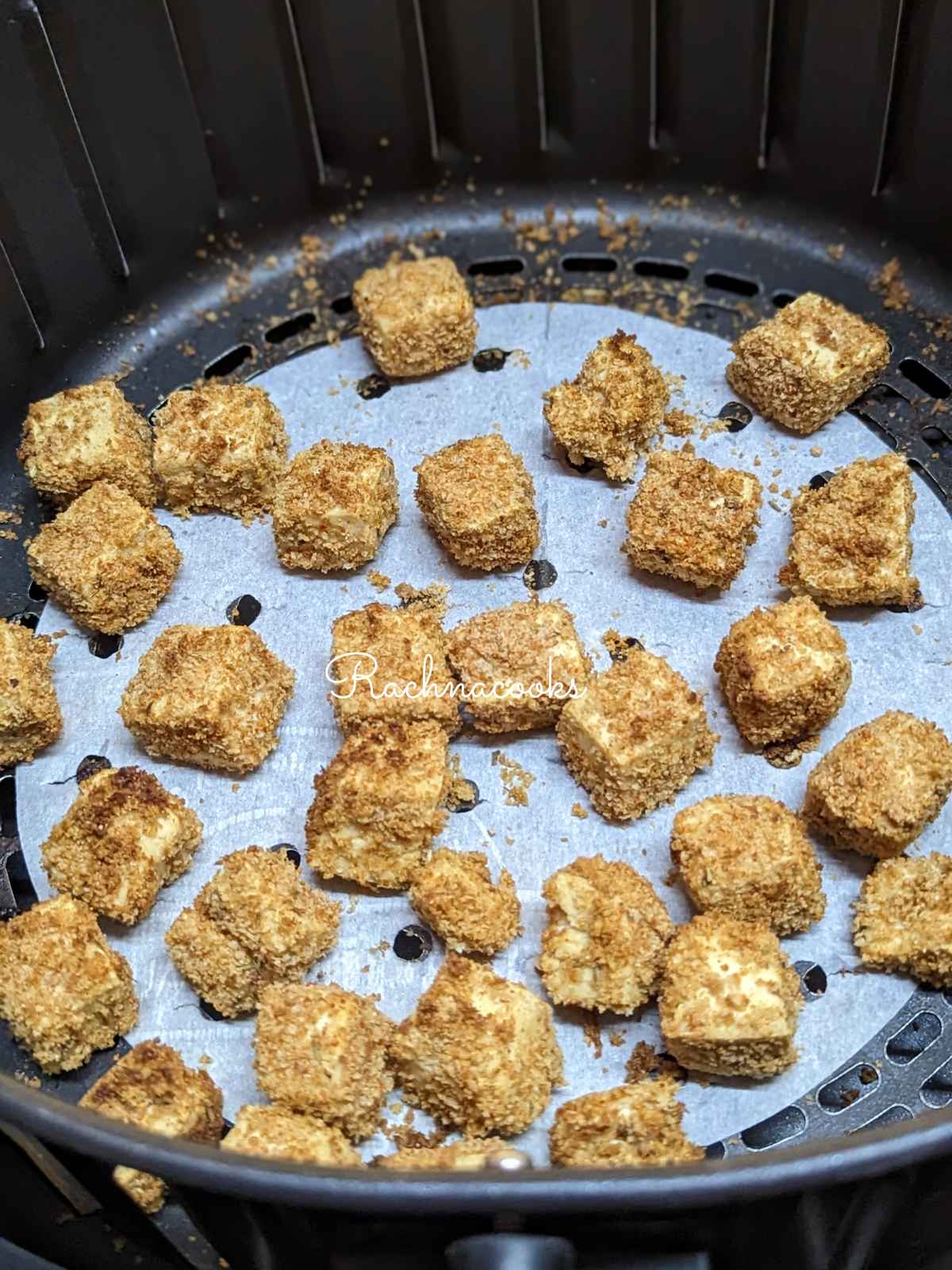 Crispy tofu after air frying in air fryer basket