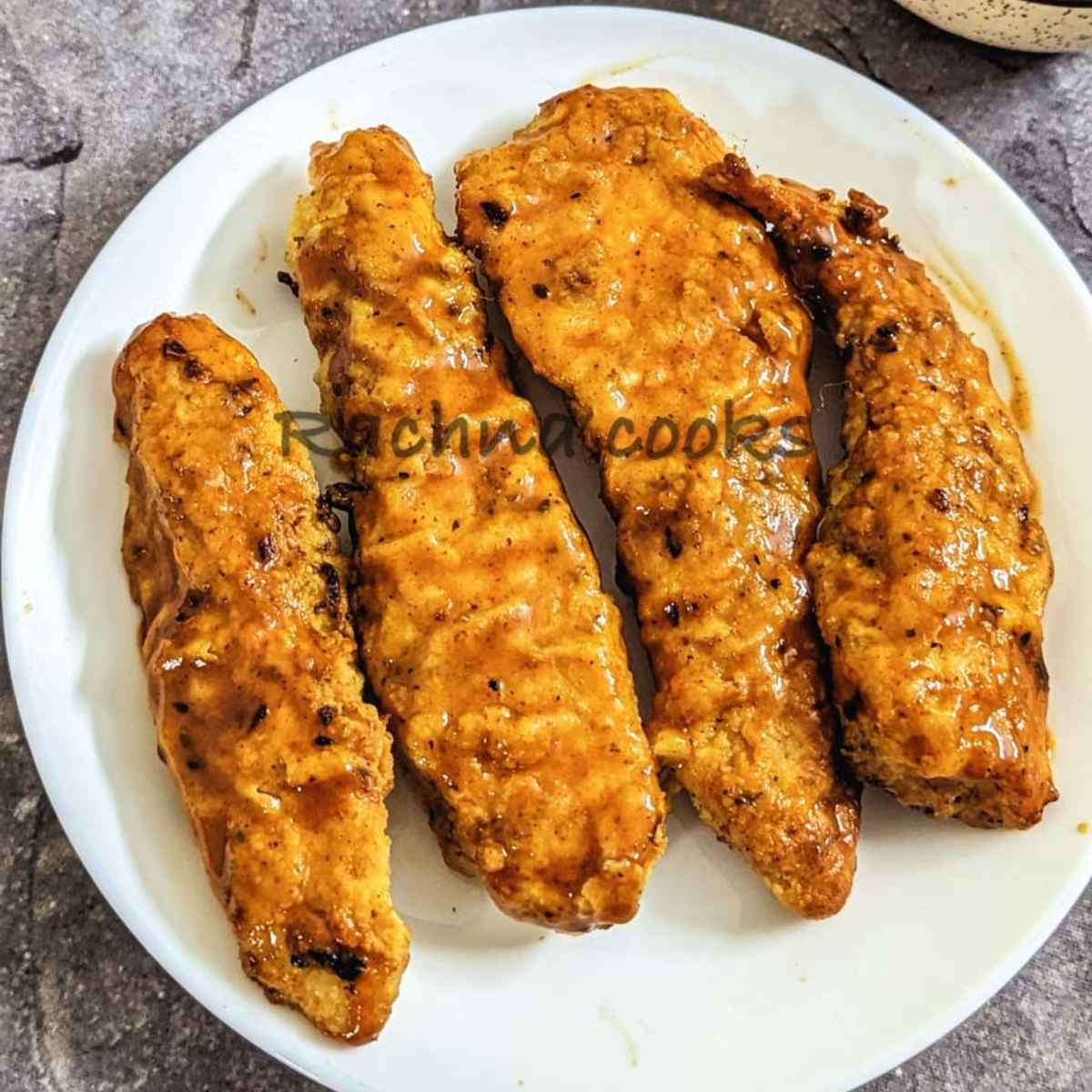 Buffalo chicken tenders on a white plate