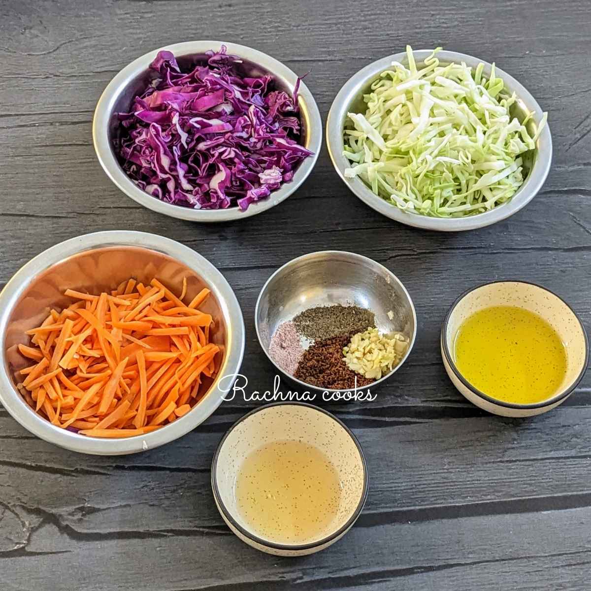 Shredded green cabbage, purple cabbage, carrots, extra virgin olive oil, apple cider vinegar, seasonings in bowls.