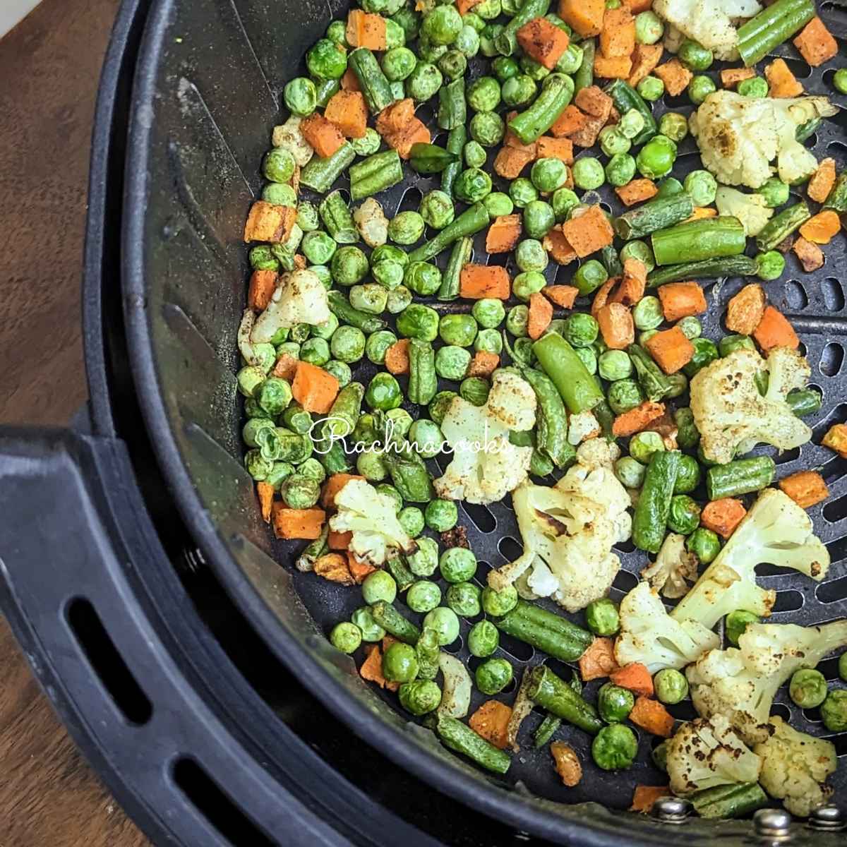 Roasted vegetables in air fryer basket after air frying