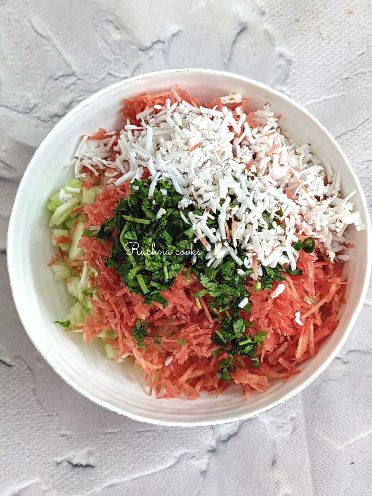 Grated cucumber with coconut, cilantro, green chilli and grated carrot in moong dal. 