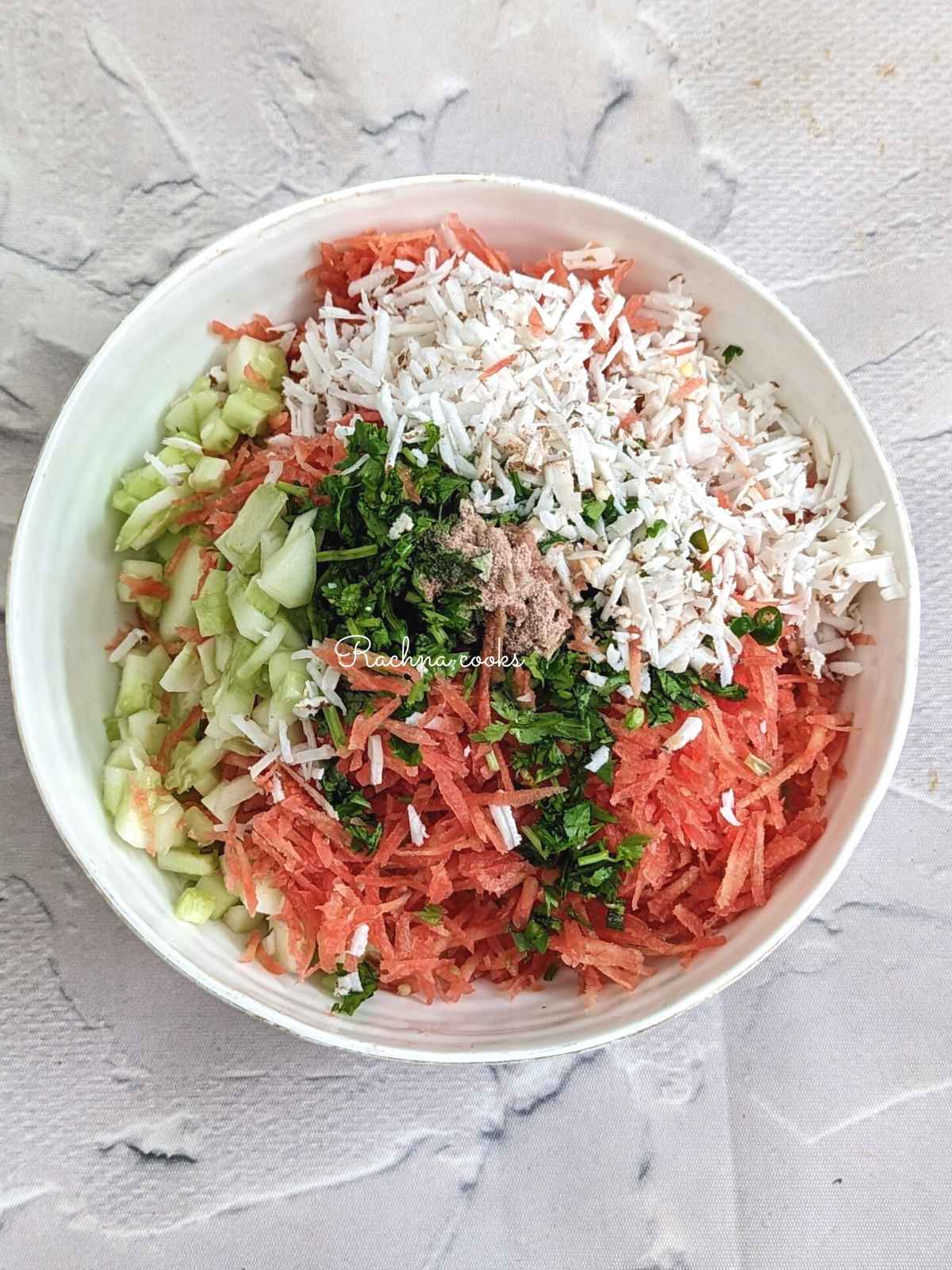 Grated cucumber with coconut, cilantro, green chilli and grated carrot in moong dal with lemon juice and salt.