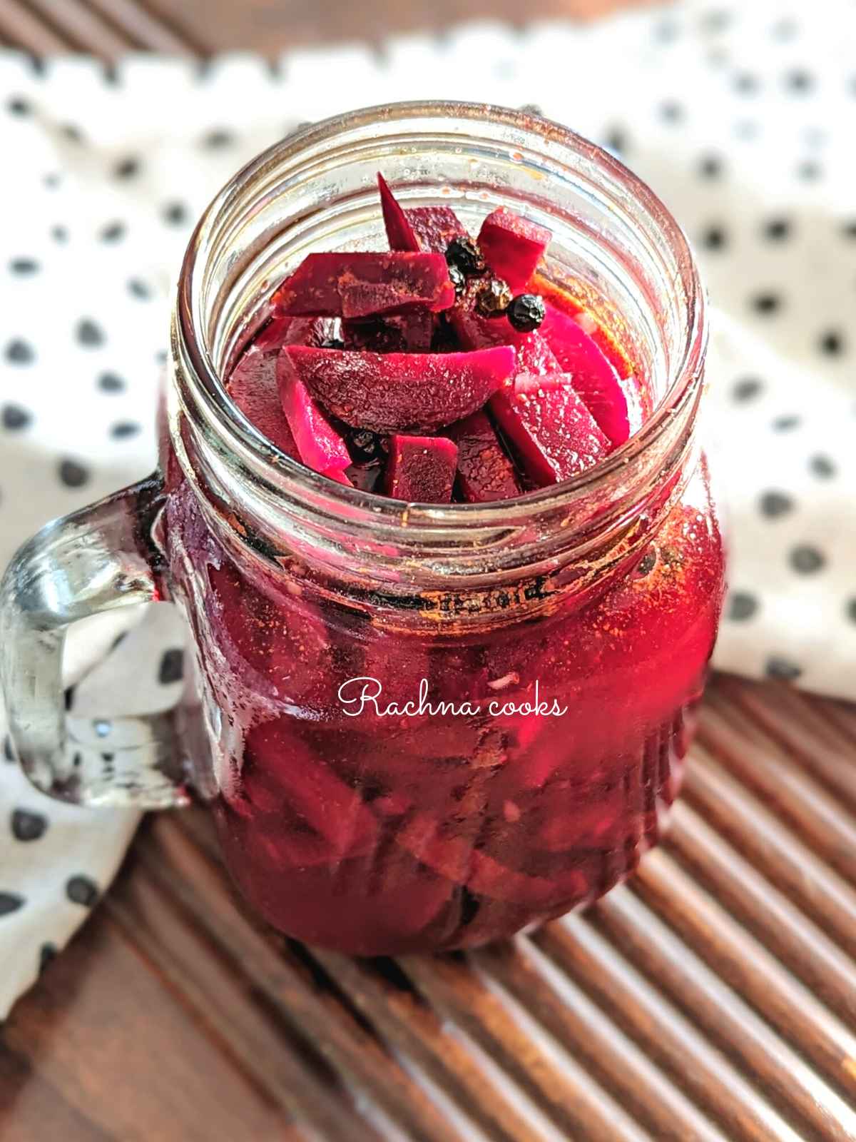 Delicious pickled beetroot batons in vinegar in a mason jar.