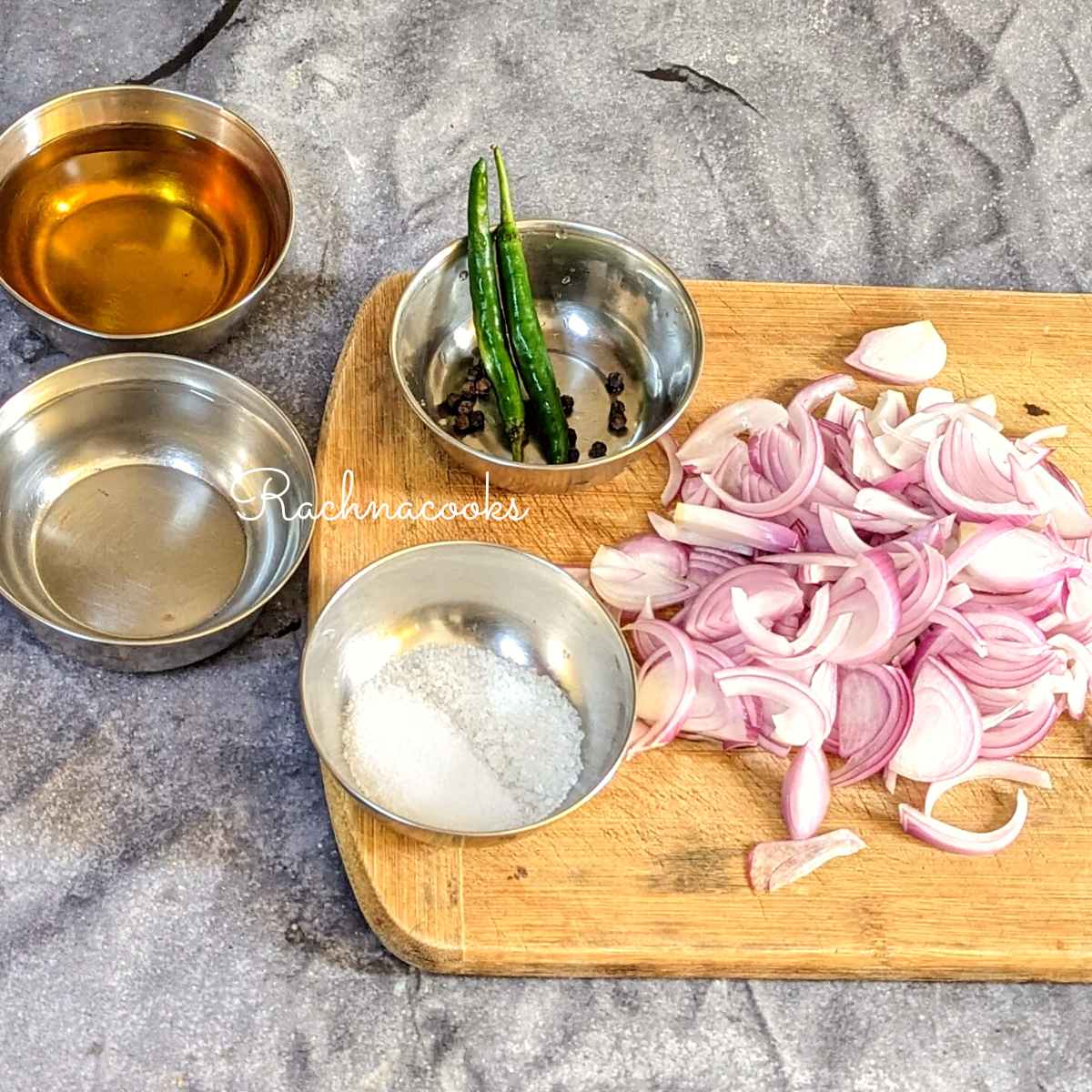 Ingredients for pickled onions: Sliced onion, slit chillies, peppercorns, salt, sugar, water and apple cider vinegar.