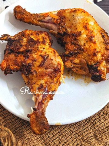 air fryer chicken leg quarters served on a white plate.