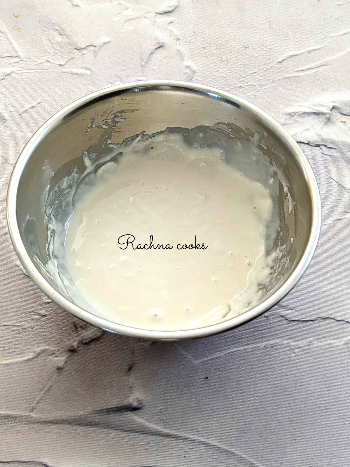 Pancake batter prepared in a shallow bowl after mixing pancake batter with water.