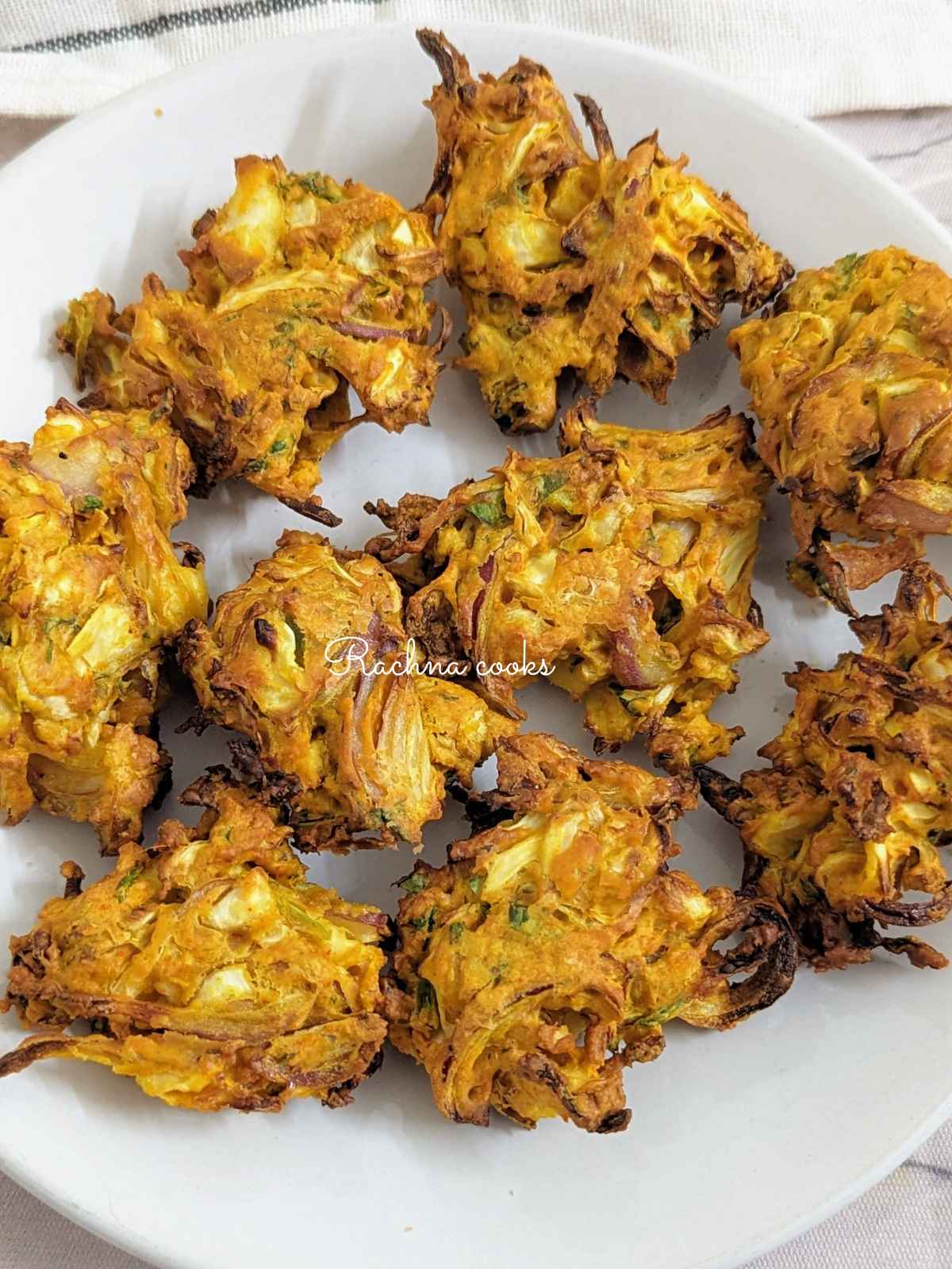 Air fried cabbage pakoda served on a white plate.