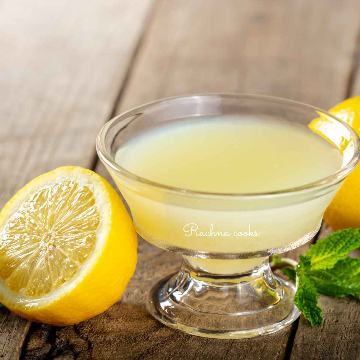 lemon juice in a glass bowl with a split lemon