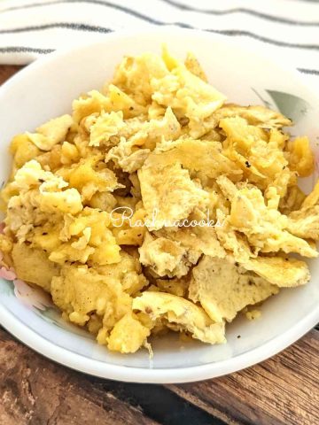 Air fried scrambled eggs in a white bowl