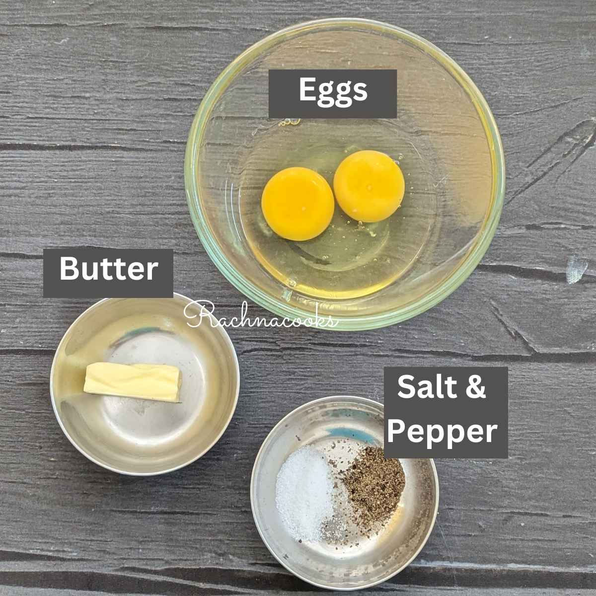Ingredients for making scrambled eggs in air fryer showing cracked eggs, butter and salt and pepper.