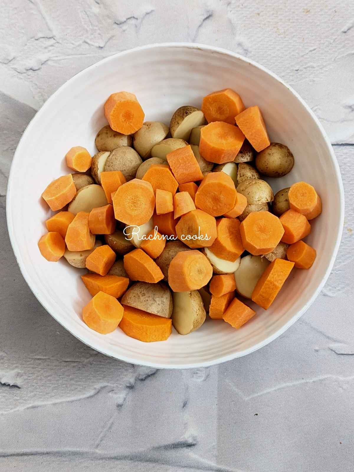 Chopped carrots and potatoes in a bowl
