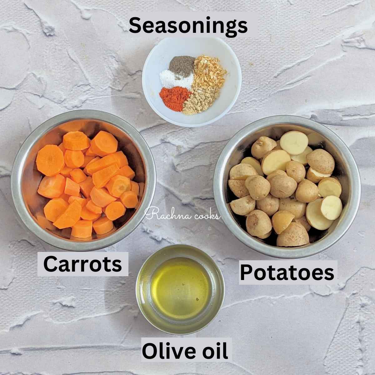 Ingredients for air fryer carrots and potatoes: carrots, potatoes, seasonings and olive oil in different bowls.