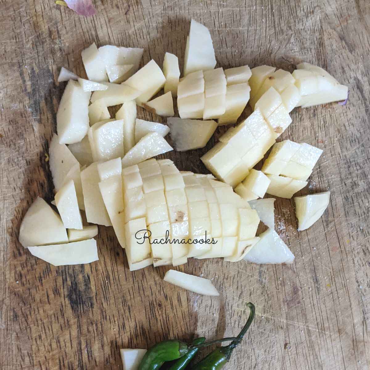 Chopped parsnips or radish on a chopping board.