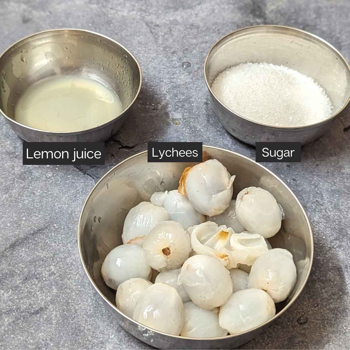 whole lychees, sugar and lemon juice in shallow bowls