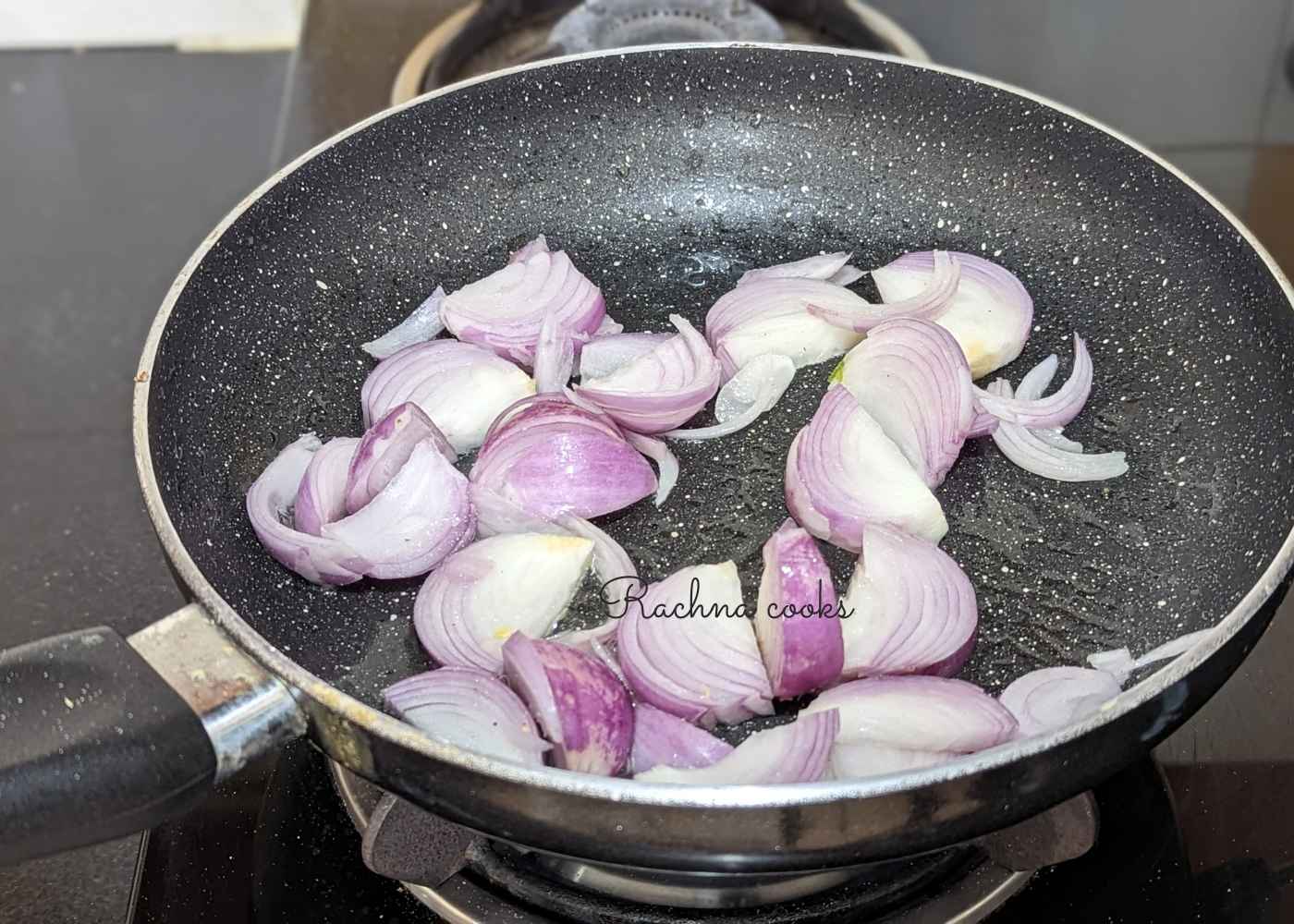 1 onion being sauteed in a pan