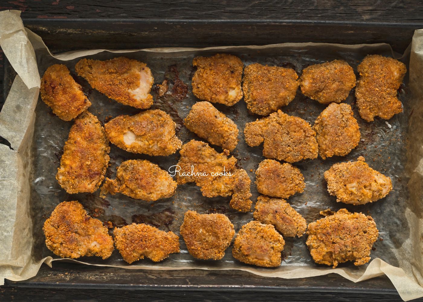 McDonald's Mcnuggets on a baking tray being heated.