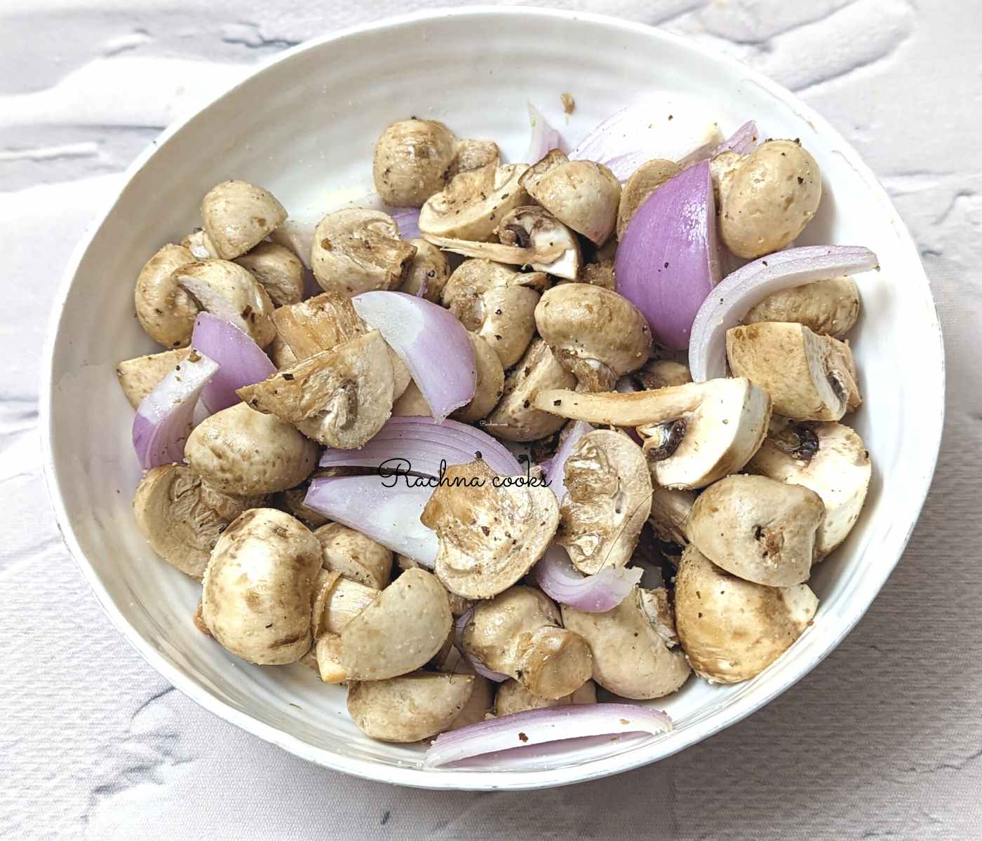 Chopped mushroom and sliced onion in a bowl