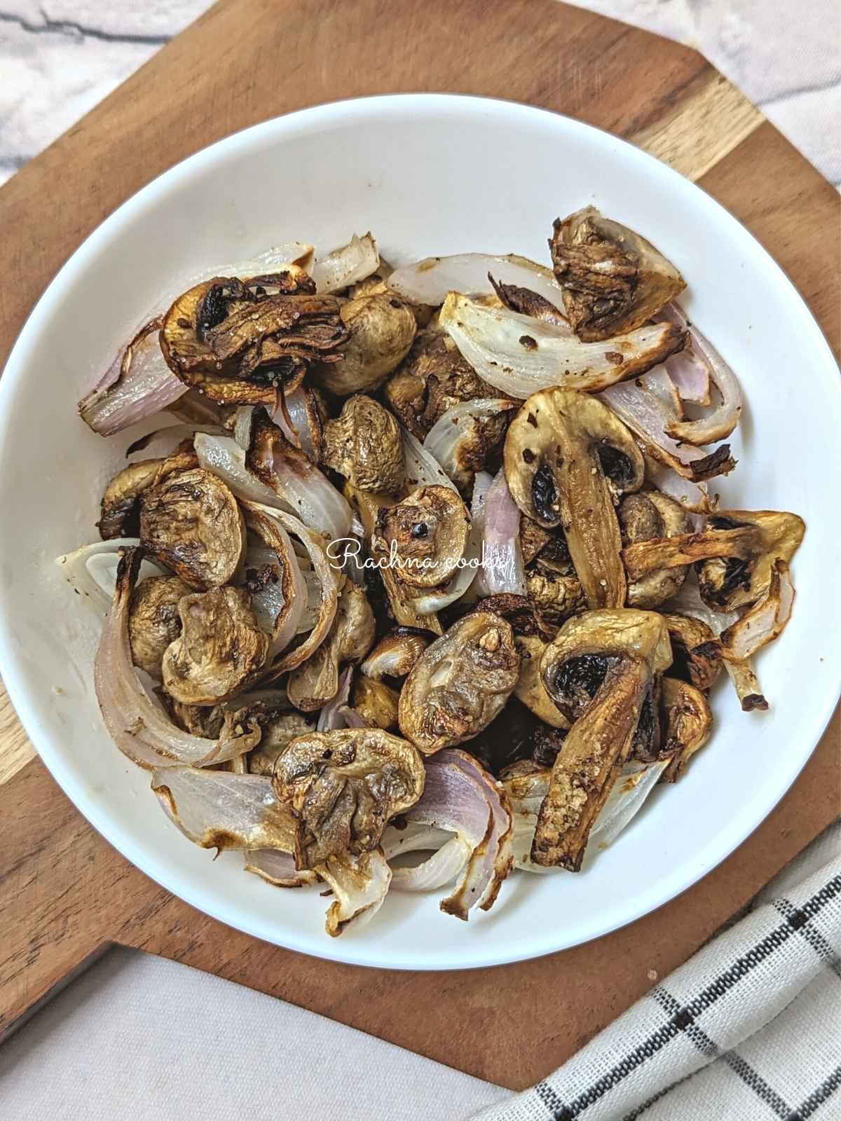 Air fryer mushroom and onion in a white plate.