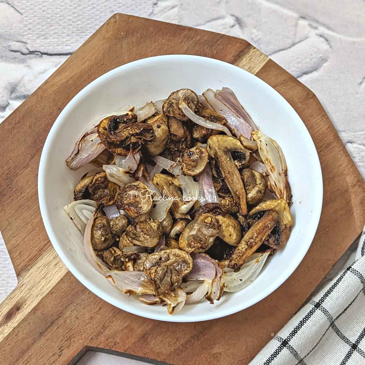 Air fryer mushroom and onion in a white plate.