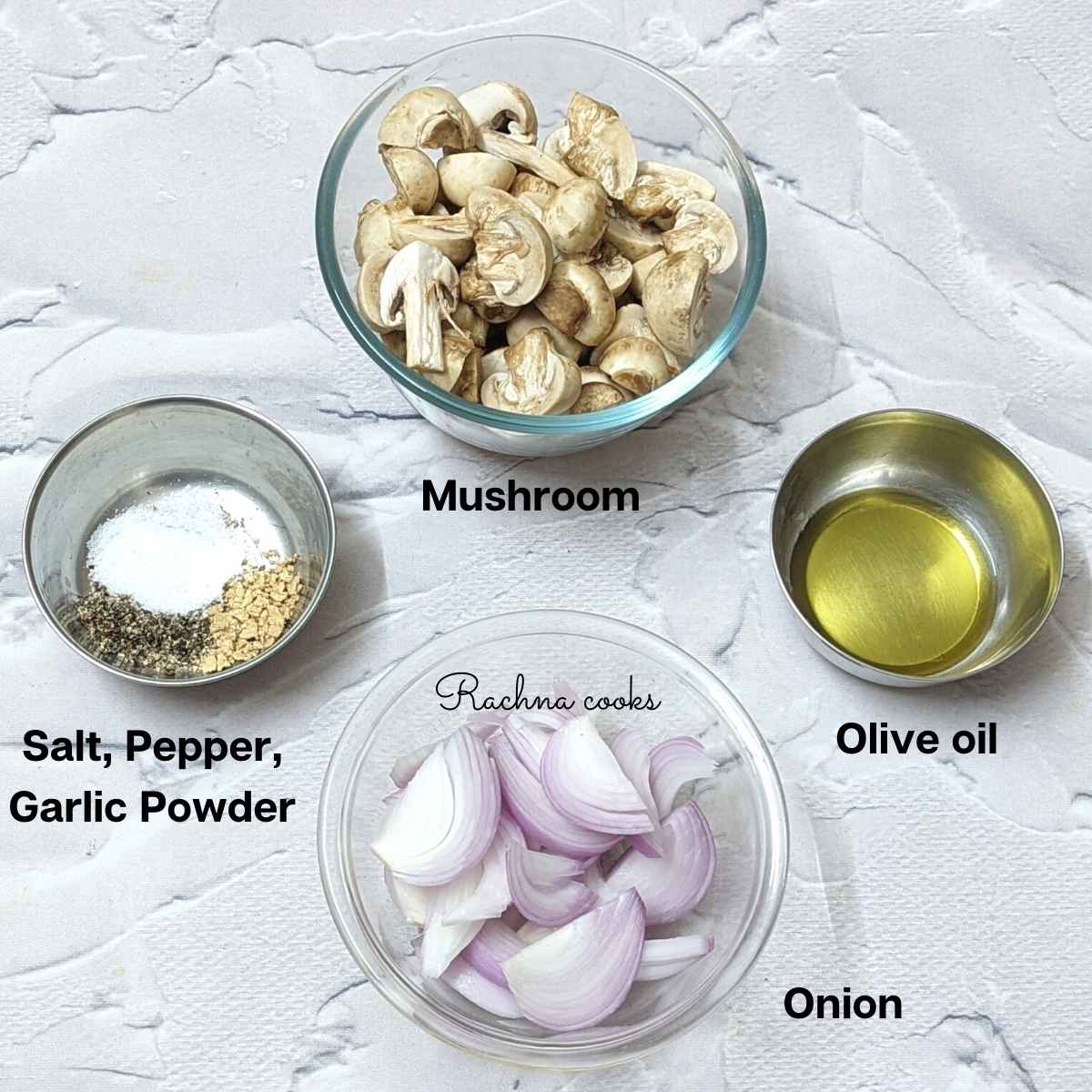 Ingredients for air fryer mushroom on a board: chopped mushrooms, sliced onion, olive oil, salt, pepper and garlic powder.